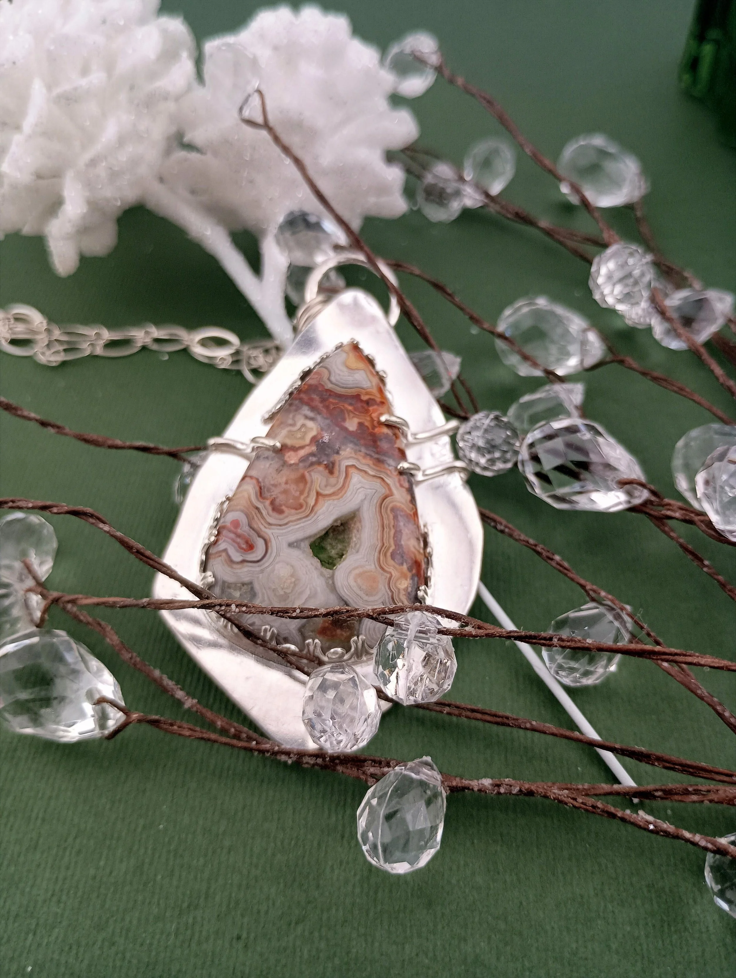 Crazy lace agate necklace green background white pinecones.JPG