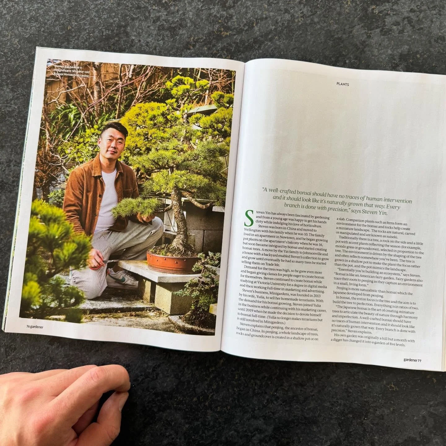 Open magazine with a photo of a man in a garden featuring a bonsai tree; the right page contains text about bonsai cultivation.