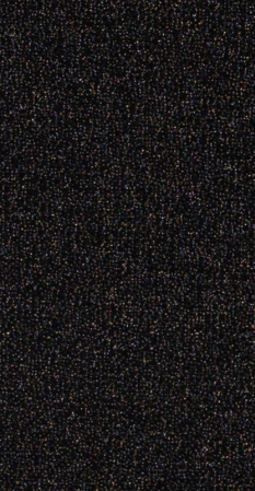 Close-up of a black glittery surface with multicolored specks.