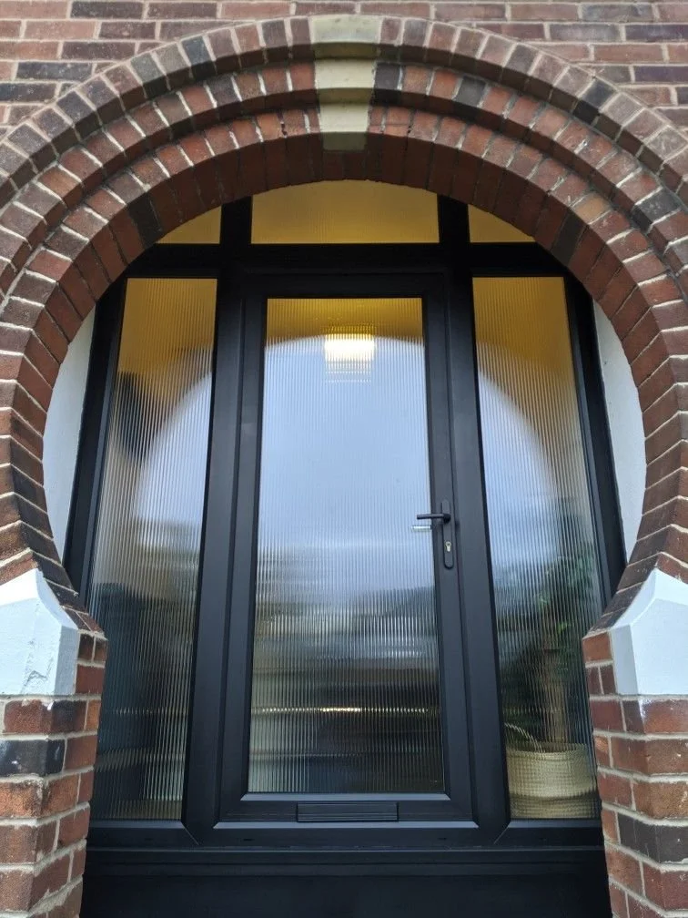 An entrance Door with reeded double glazing.