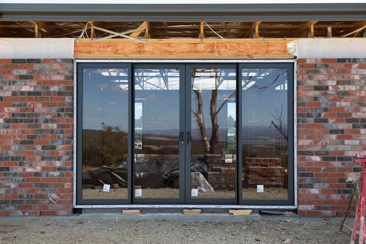 Centre-opening VarioSlide on a new-build site. Jett Black Matt uPVC frames.