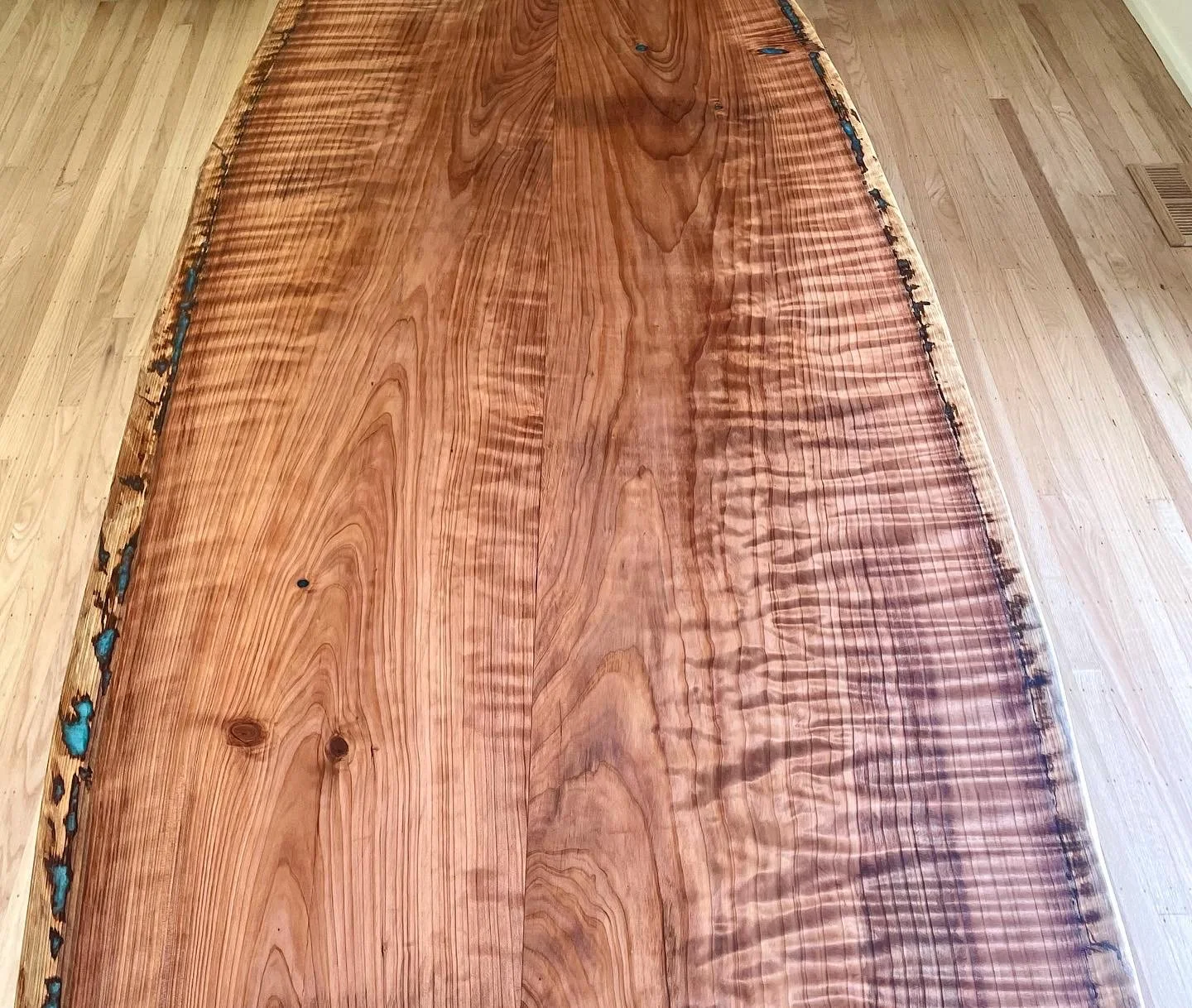 A wooden table with a polished surface and natural wood grain pattern.