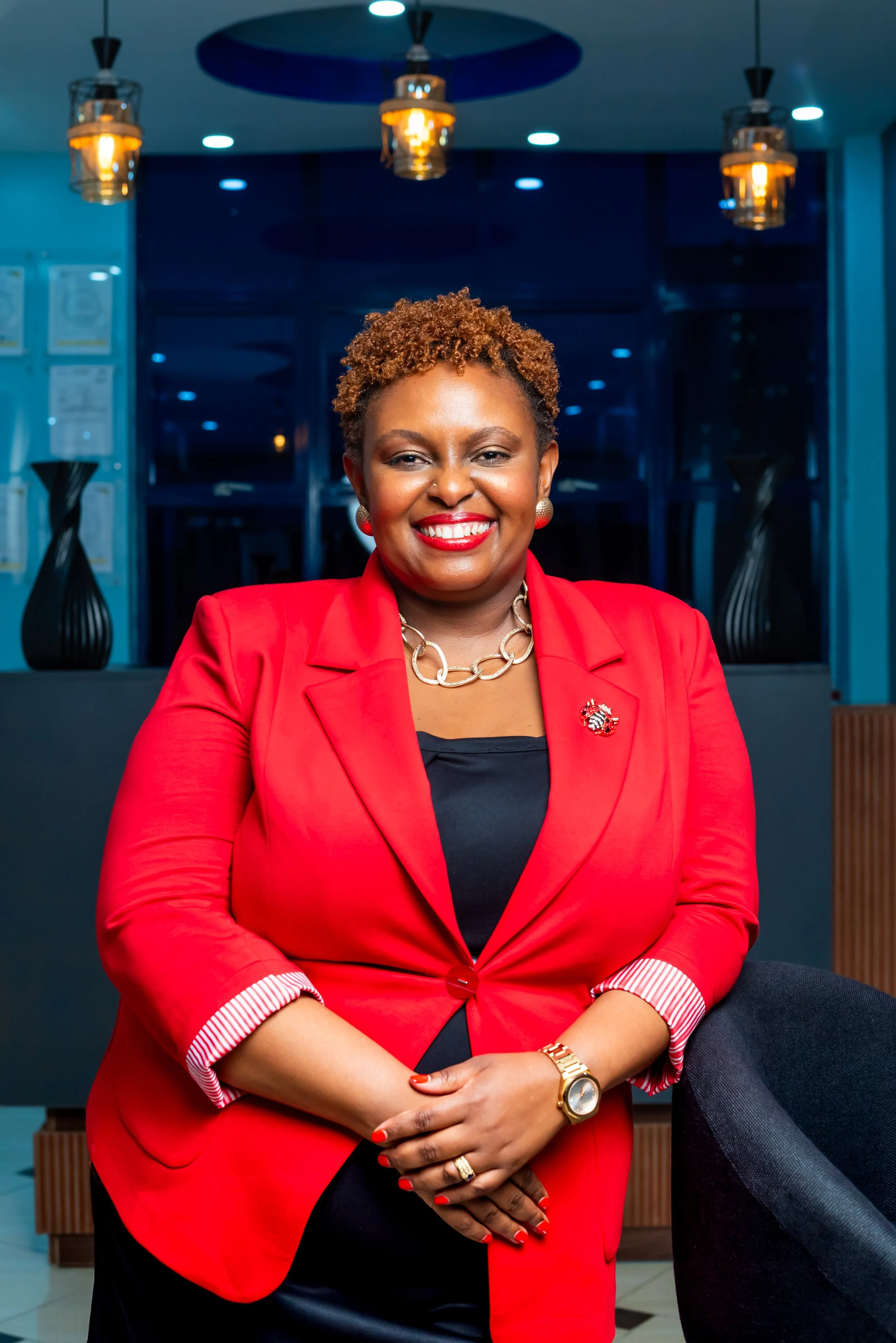 Anne Mubia–Murungi, Viva's Partner standing in a modern indoor setting with blue lighting.