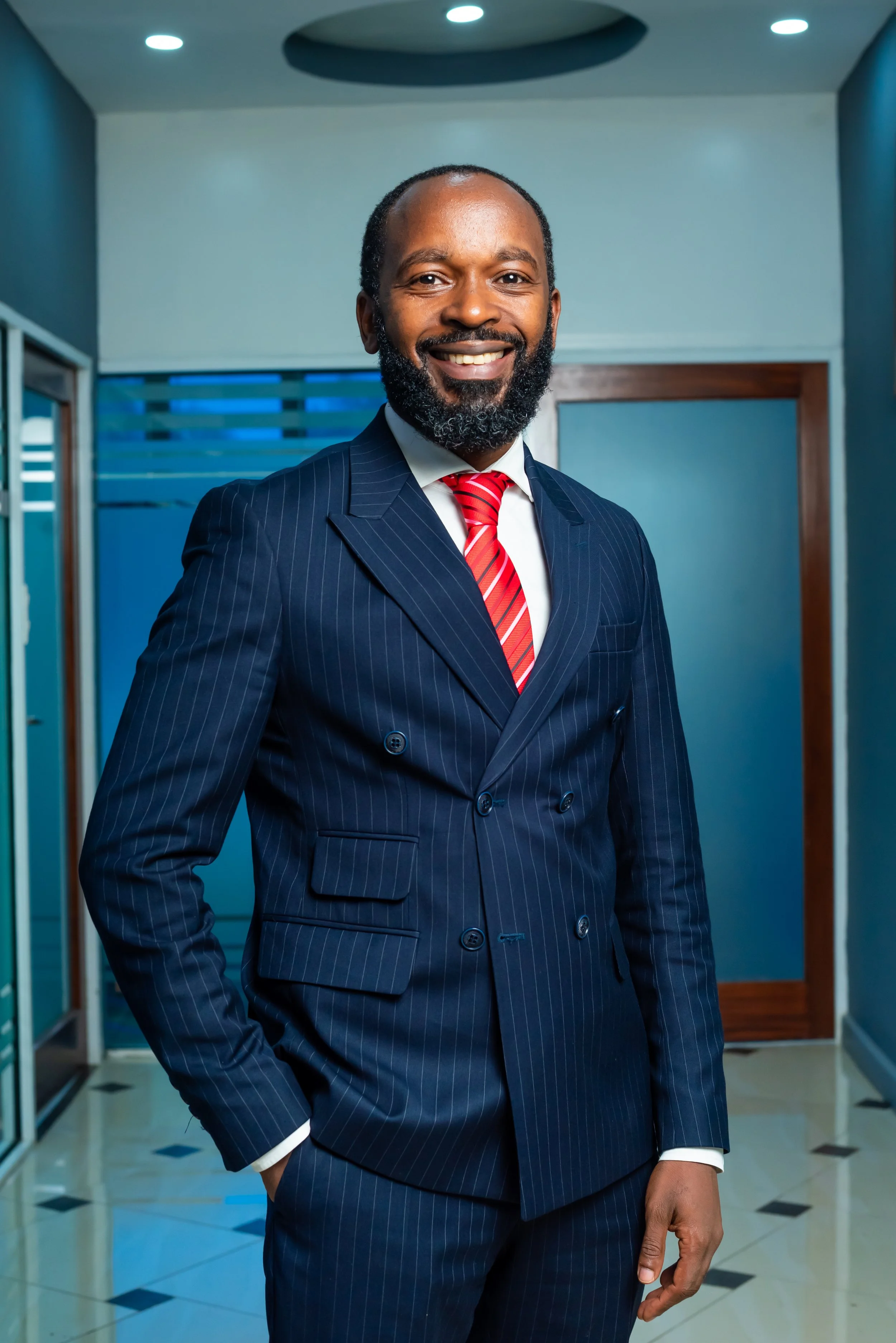 Emmanuel Laalia Viva's Partner, standing indoors in a professional setting, smiling at the camera.