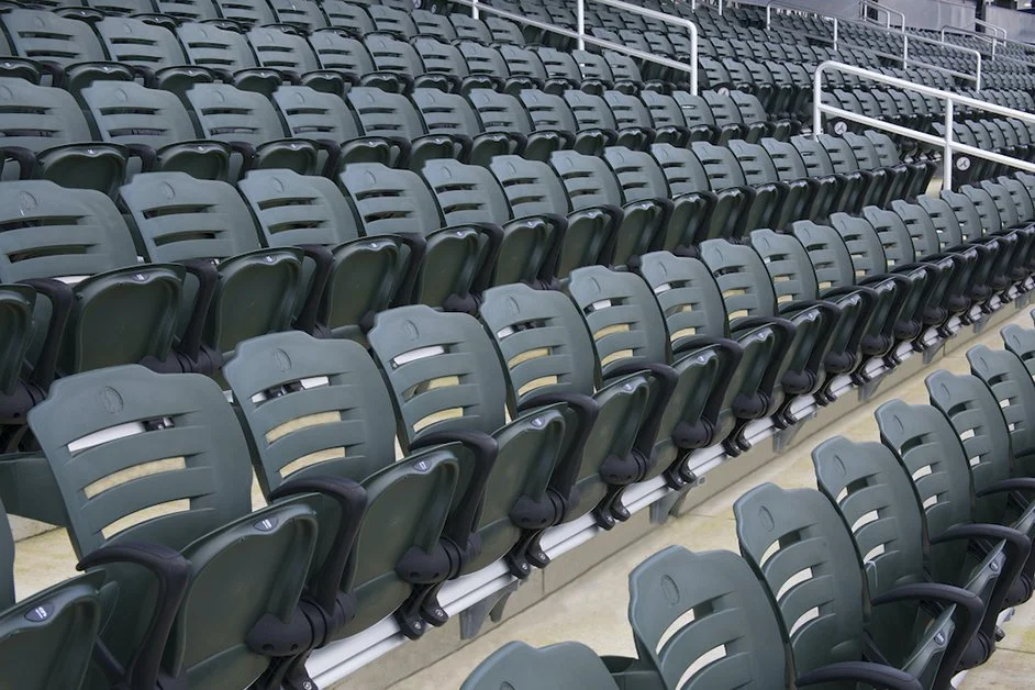 Empty stadium seats in a sports arena or auditorium.