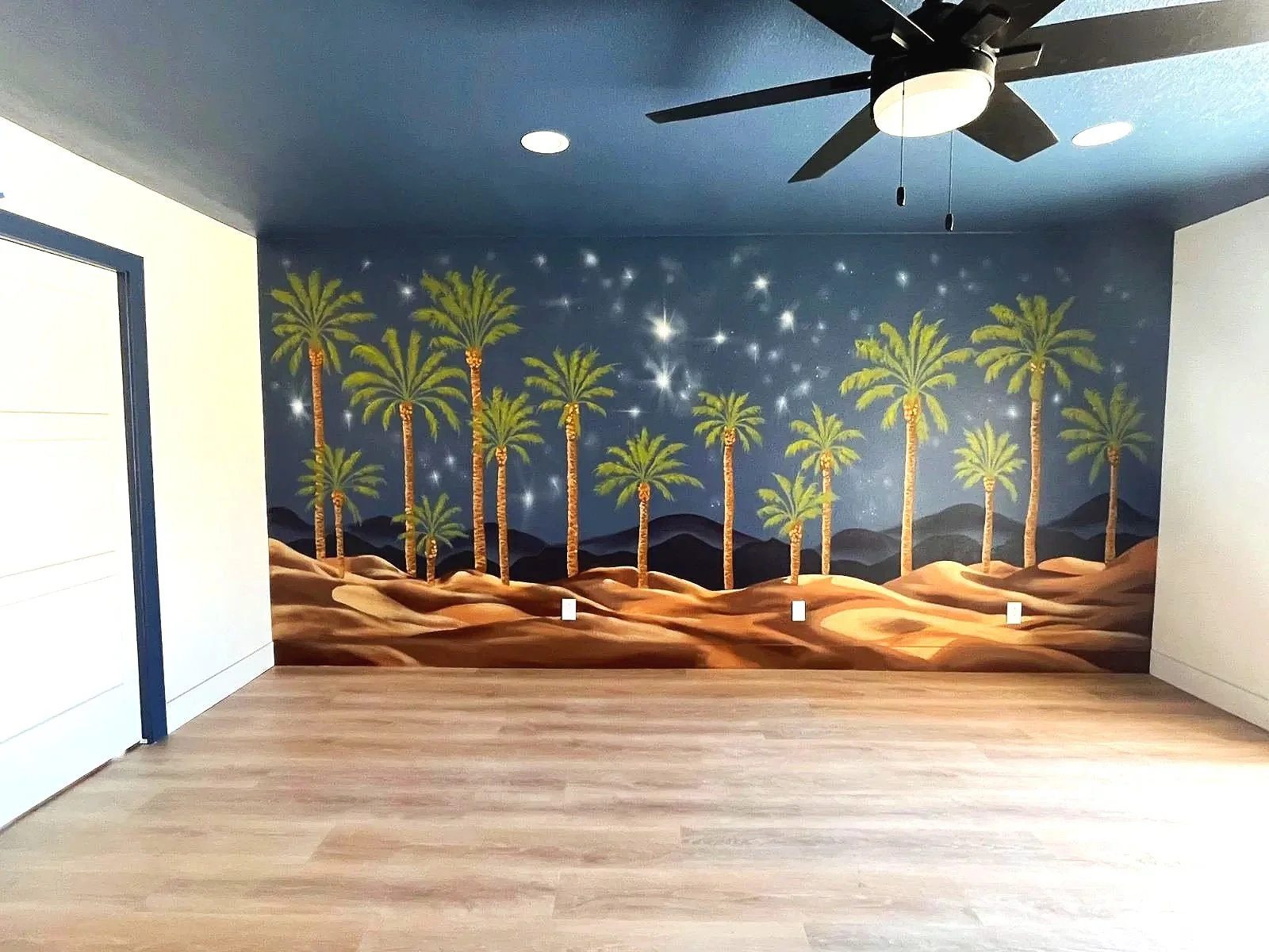 Custom palm tree and desert night sky mural by Jade Bamford Murals for a Scottsdale Arizona Airbnb rental.