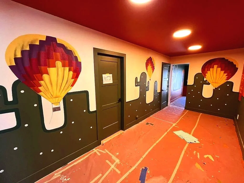Custom Arizona road map and hot air balloon mural by Jade Bamford Murals for a Scottsdale Airbnb rental.