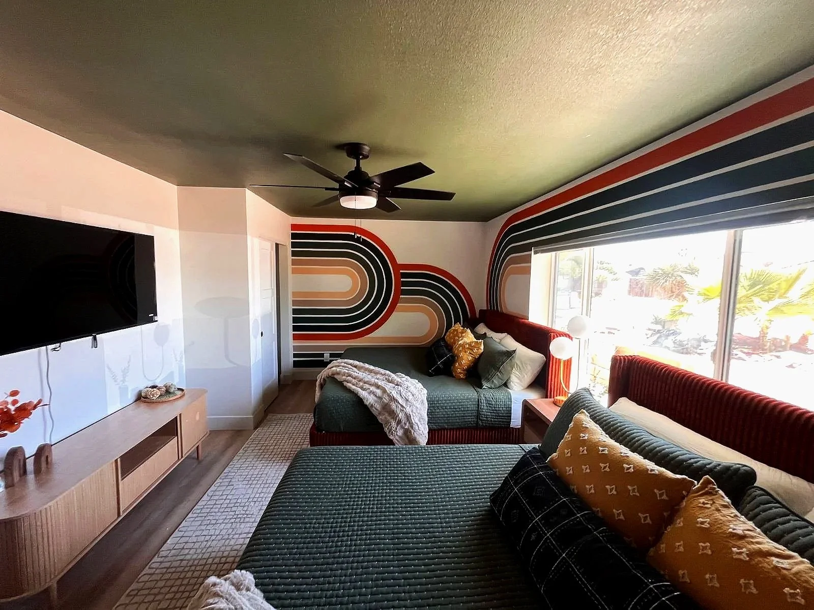 Custom retro rainbow arch accent wall mural by Jade Bamford Murals for a Scottsdale Arizona Airbnb.