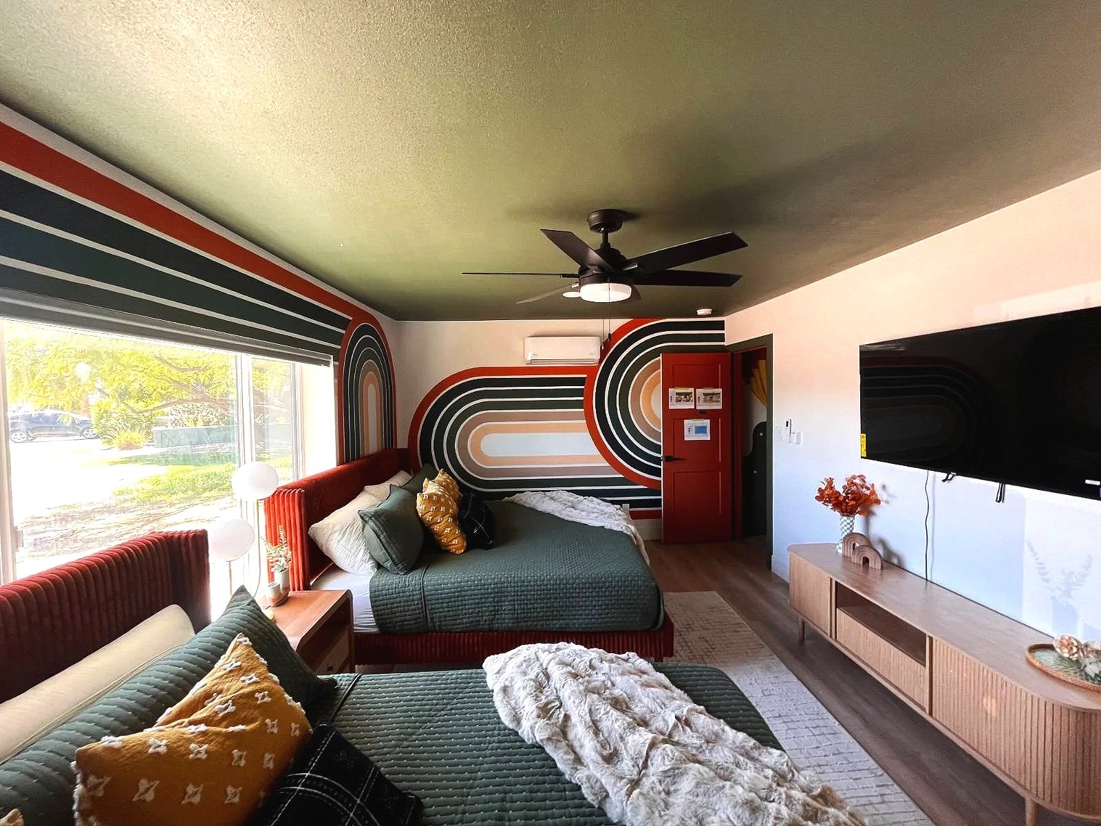 Custom retro rainbow arch accent wall mural by Jade Bamford Murals for a Scottsdale Arizona Airbnb.