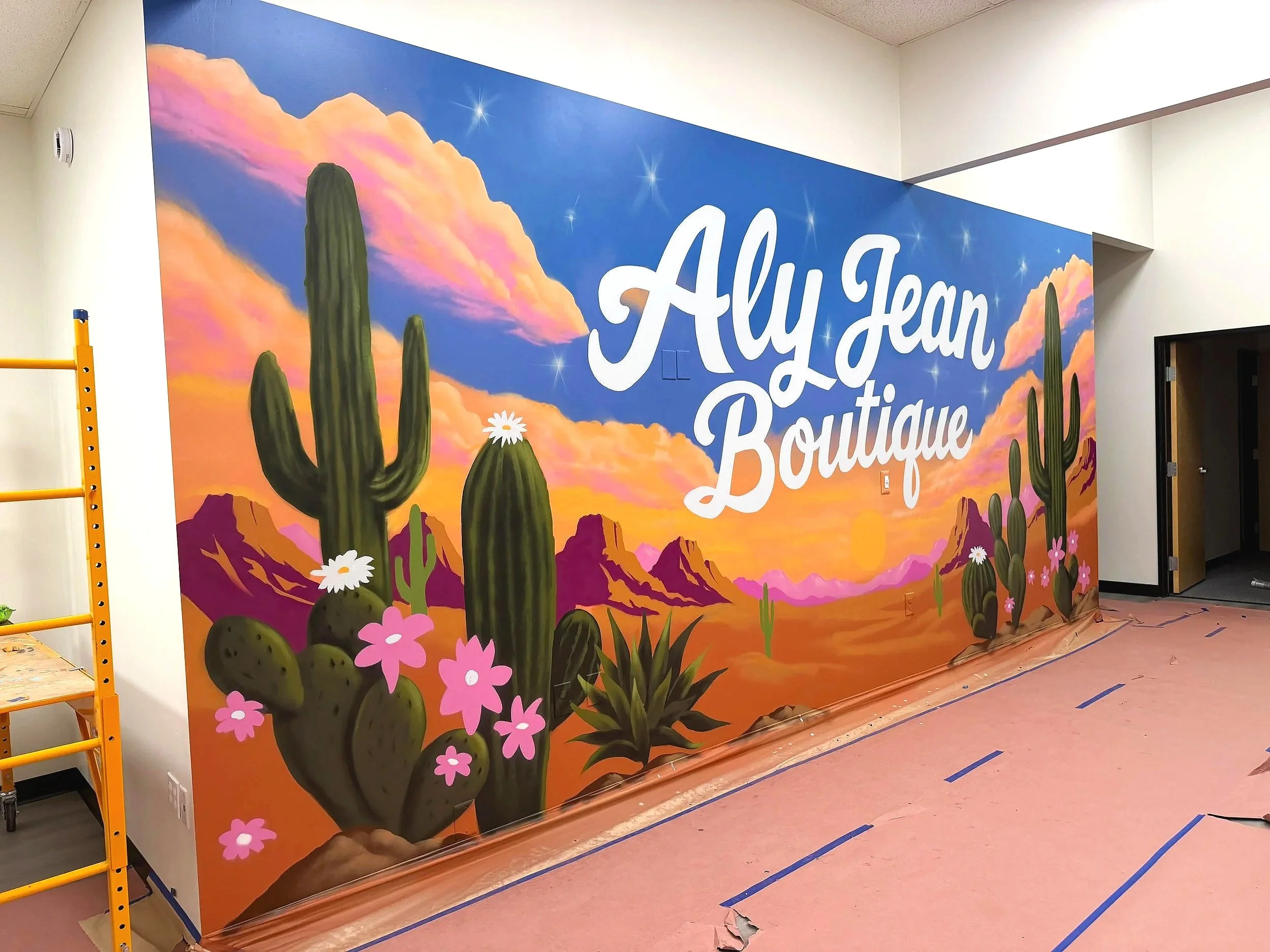 Custom hand-painted commercial wall mural for Aly Jean Boutique by Jade Bamford Murals in Mesa, Arizona.