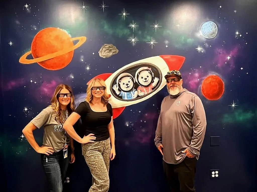 Custom space mural with astronaut bears and a rocket ship at Starlight Academy for Autistic Children in Mesa, Arizona