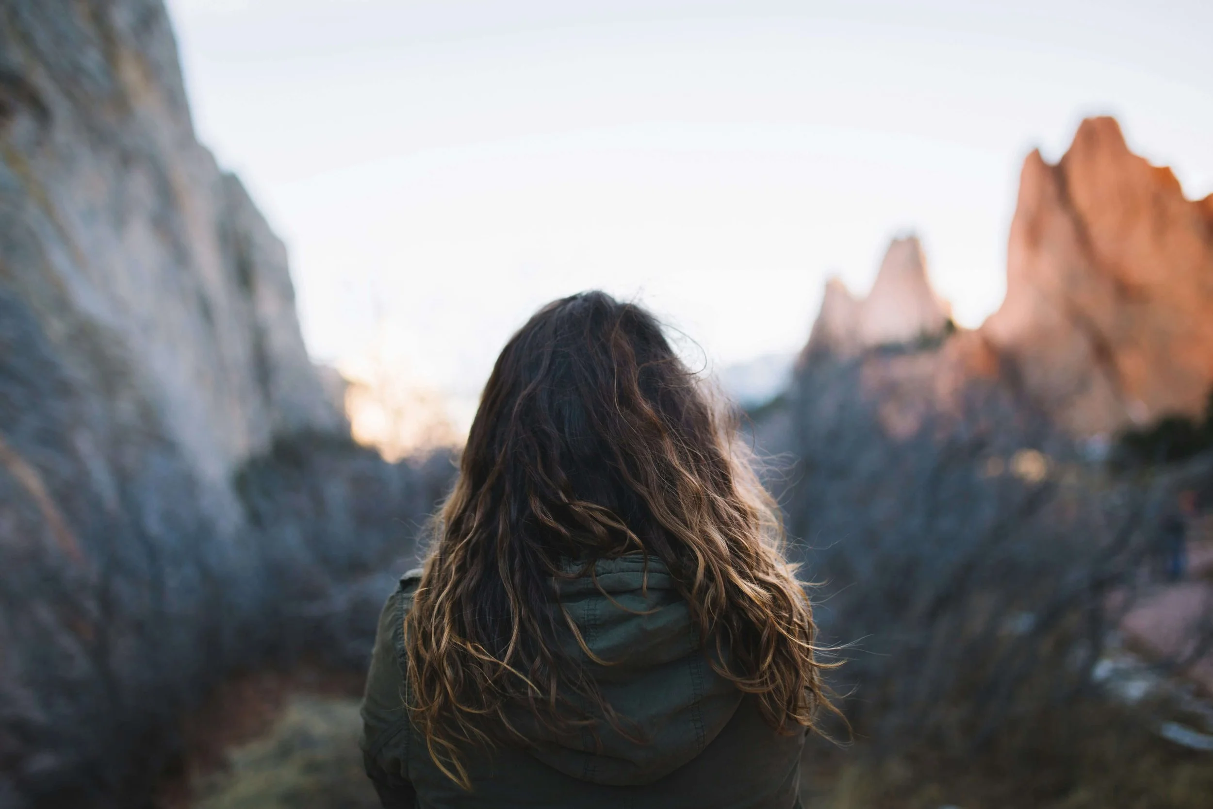 Woman looking out to a picturesque mountain scene