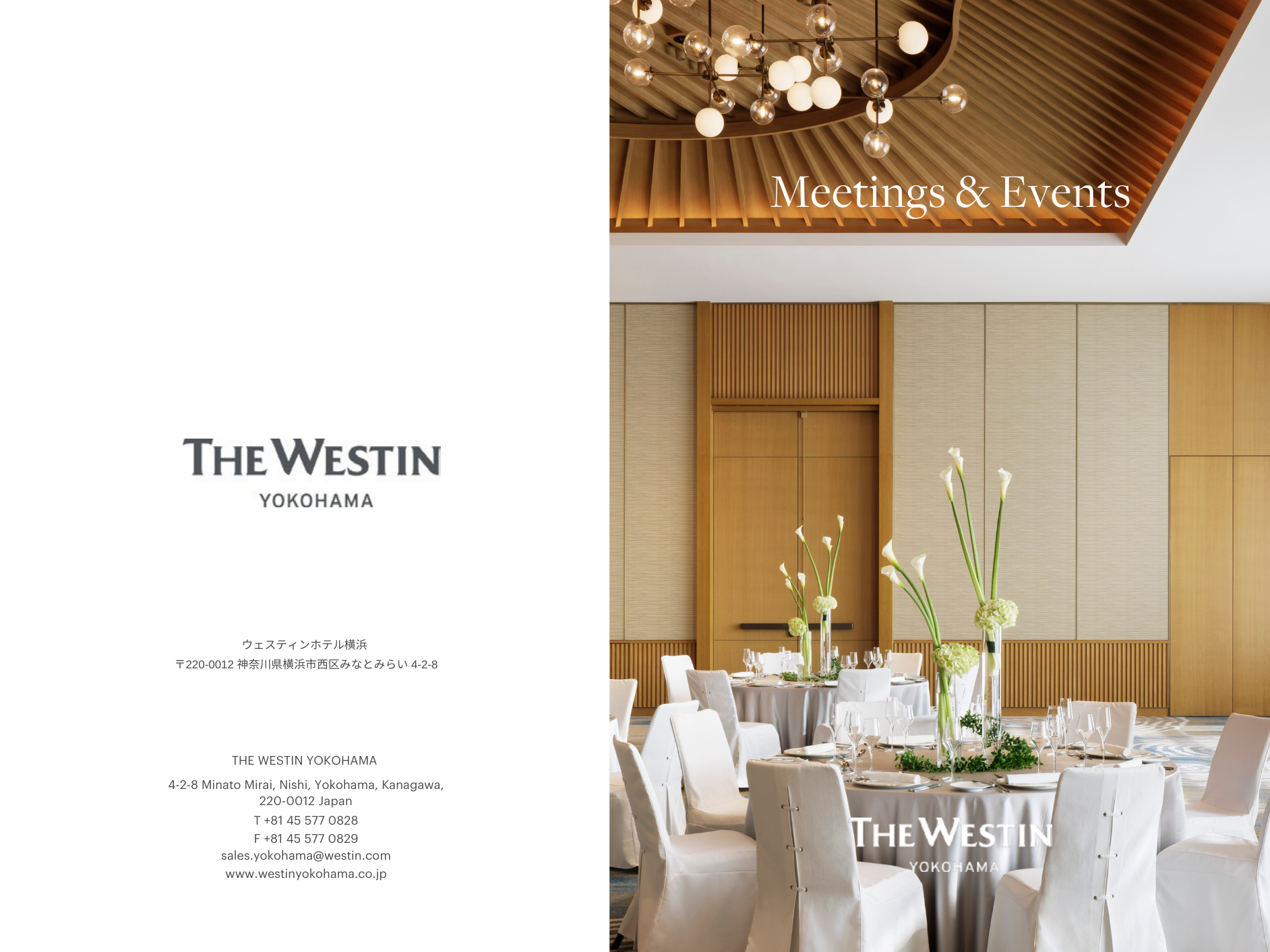 Event space with round tables decorated with tall floral centerpieces, set for a meeting or celebration, with wooden paneling and modern lighting fixtures