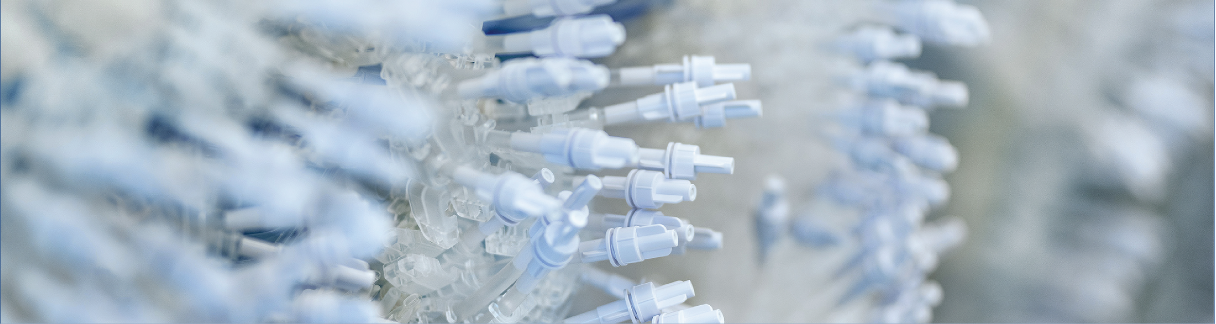 Close-up of numerous white intravenous (IV) tubing connectors clustered together.