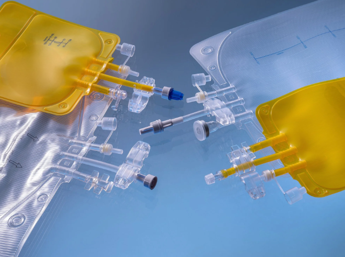 Healthcare infusion set with yellow bag and multiple connecting tubing components on a blue background.