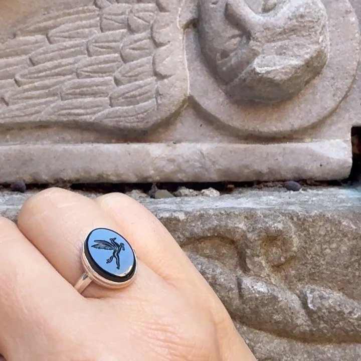 This hand-carved intaglio ring features a Pegasus on a polished black onyx oval.

What makes this jewel exceptional is its unity: both the hand-carved intaglio and the jewelry itself are created by me, making it a rare work where stone and metal spea