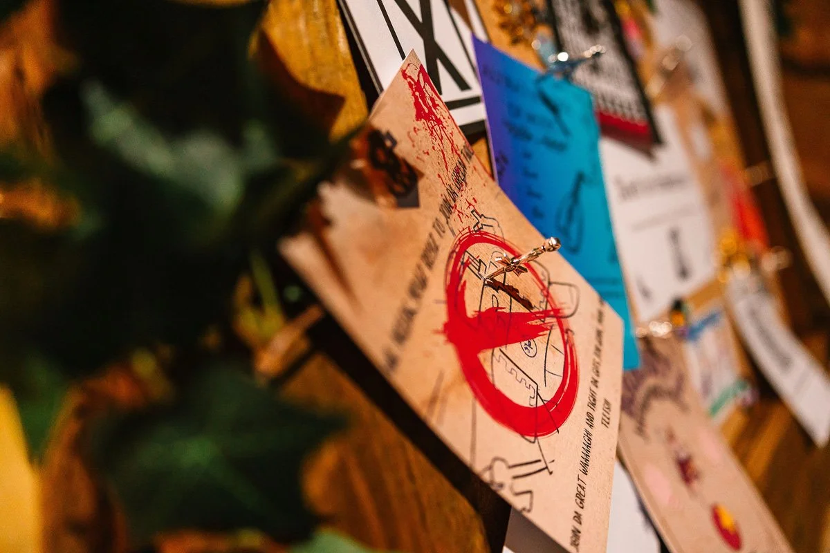 A wedding sign made of faux posters attached to a board with tiny daggers   