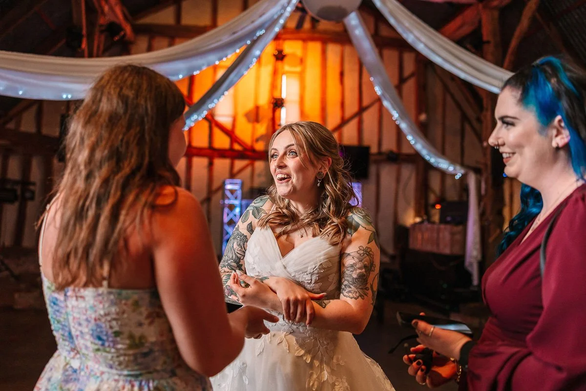  The bride smiles as she welcomes a guest 