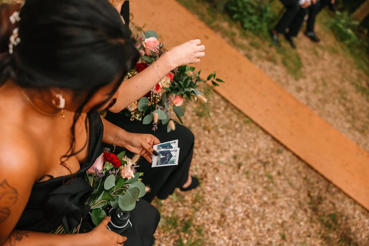  An overhead image of a girl looking at a polaroid photo 