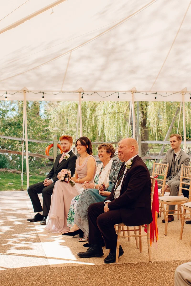 Documentary image of guests watching a ceremony at houchins wedding venue