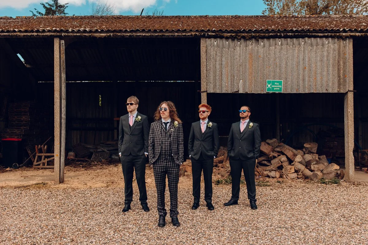 An Alternative Group photo of the Groom and Groomsmen at Houchins Wedding Venue