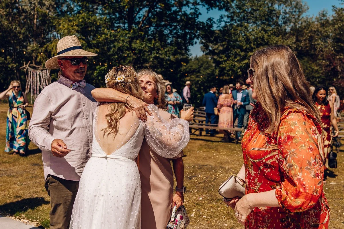 A bride hugs guests straight after the ceremony in a candid