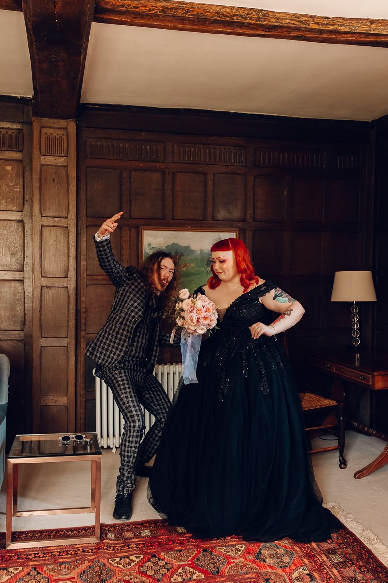 An alternative couple in black outfits dance in the house at houchins wedding venue