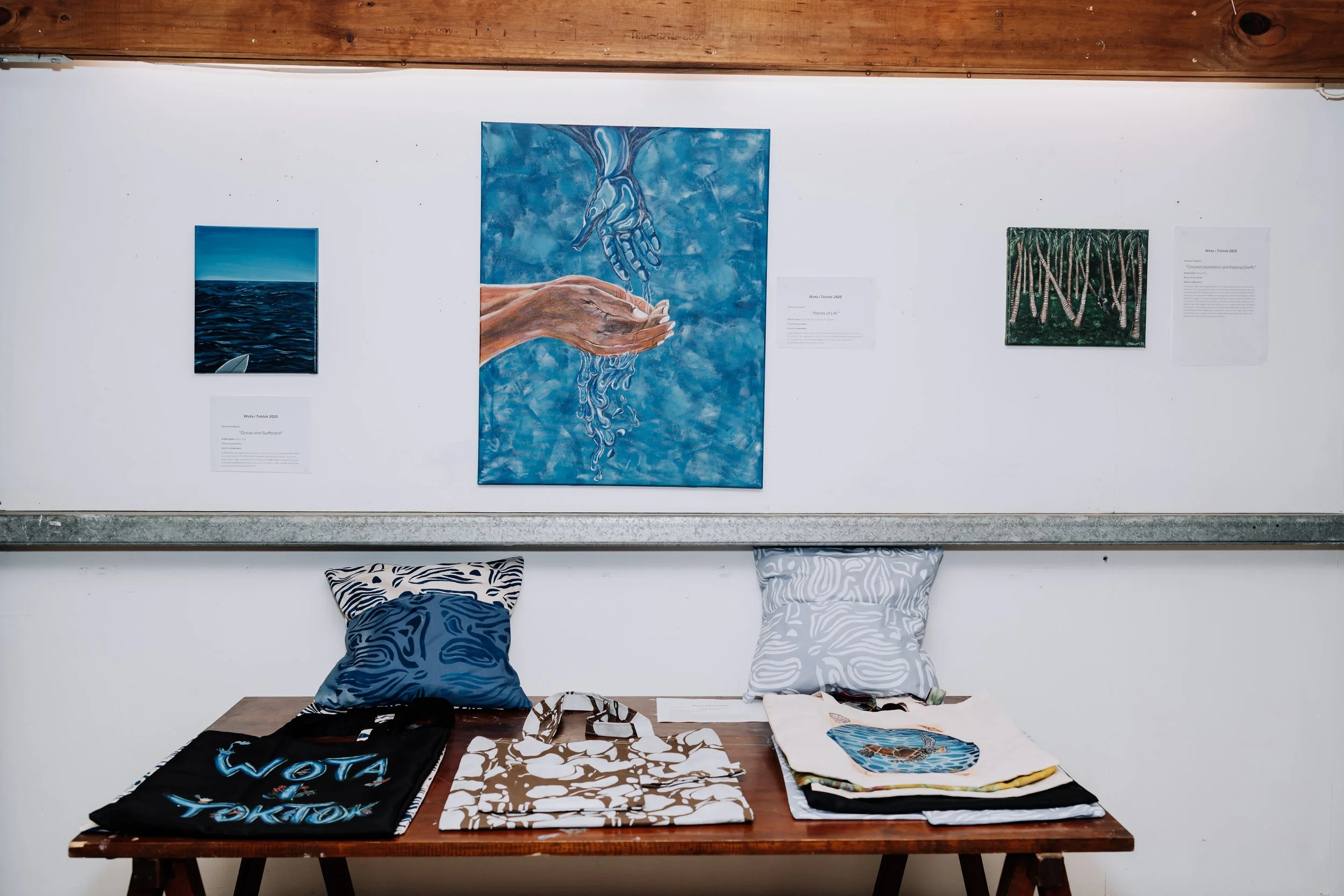 An art exhibition display including textile arts inspired by different forms of water