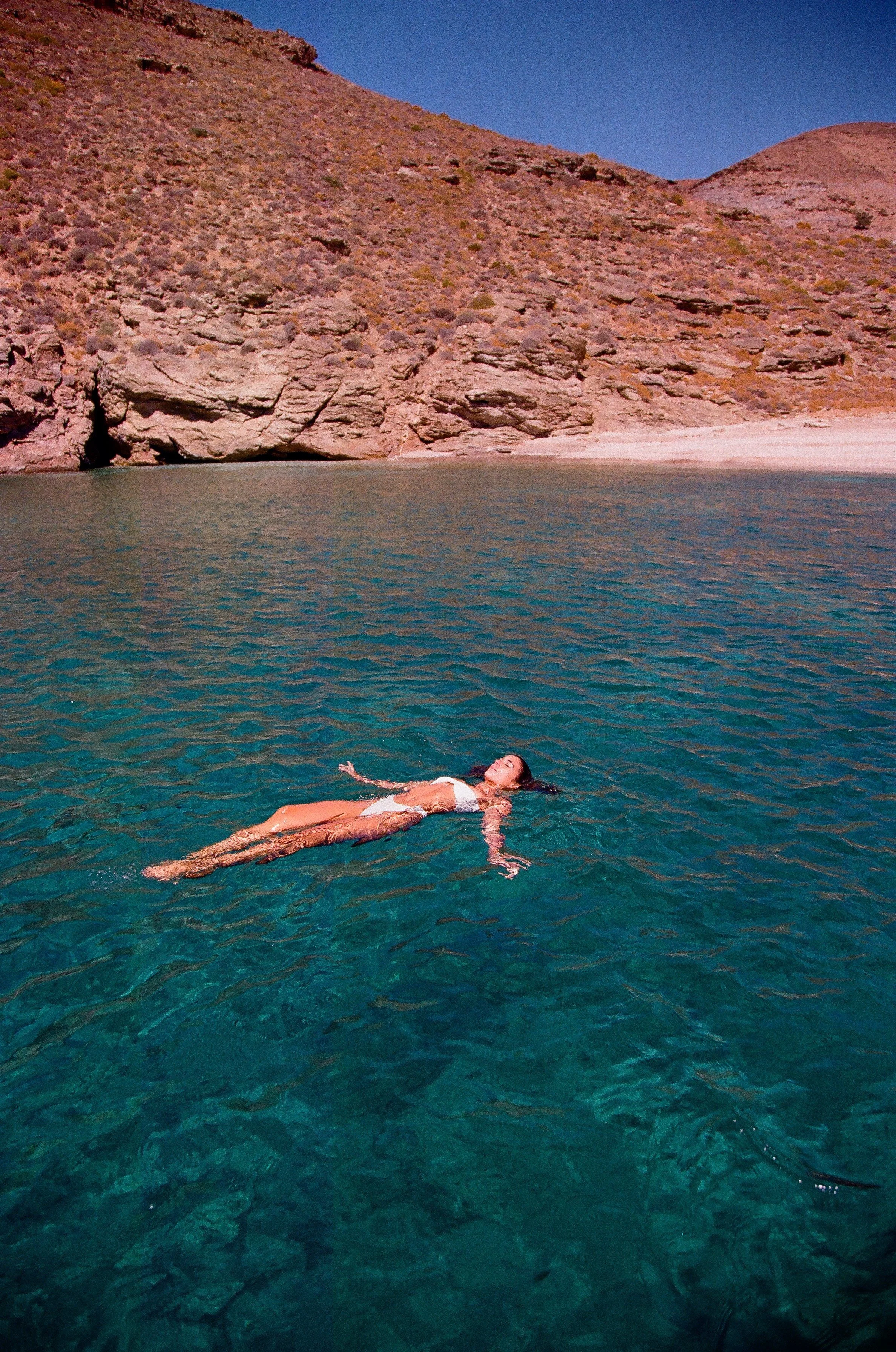 Women floating in the turquoise blue sea