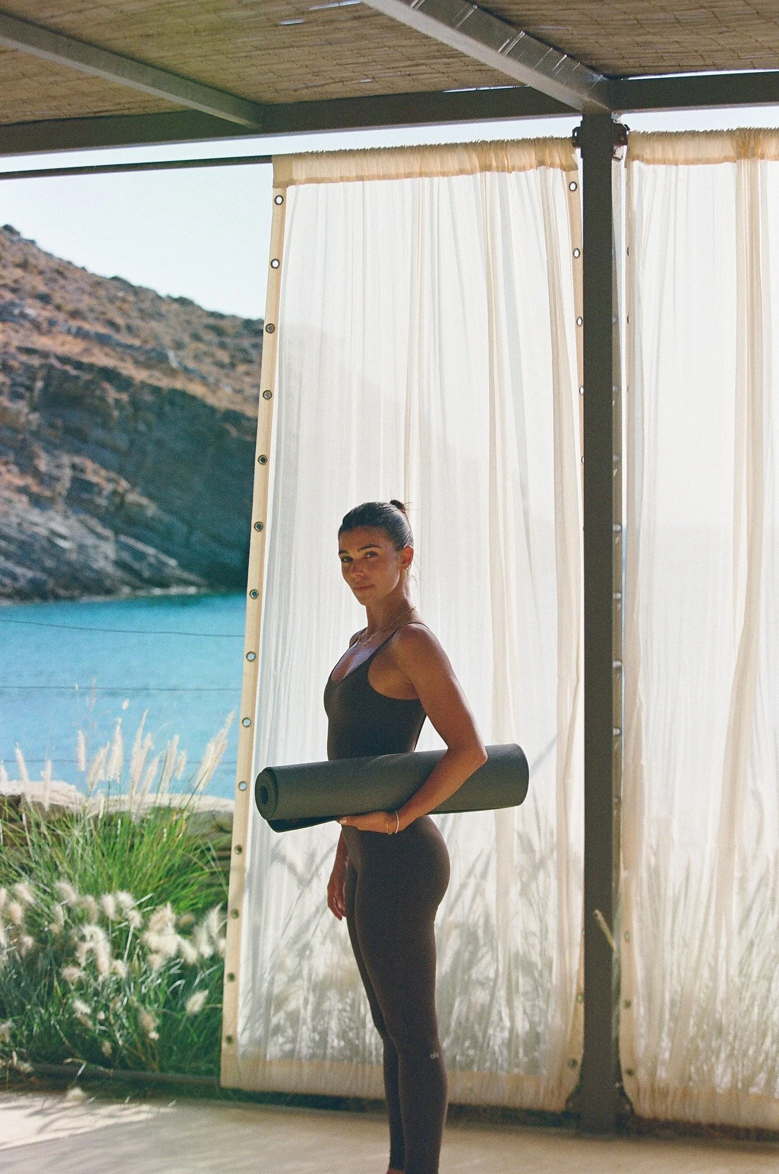 Bianca holding yoga mat
