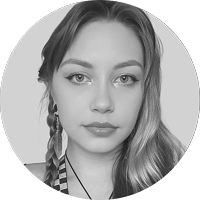 Black and white portrait of a young woman with braided hair, looking directly at the camera.