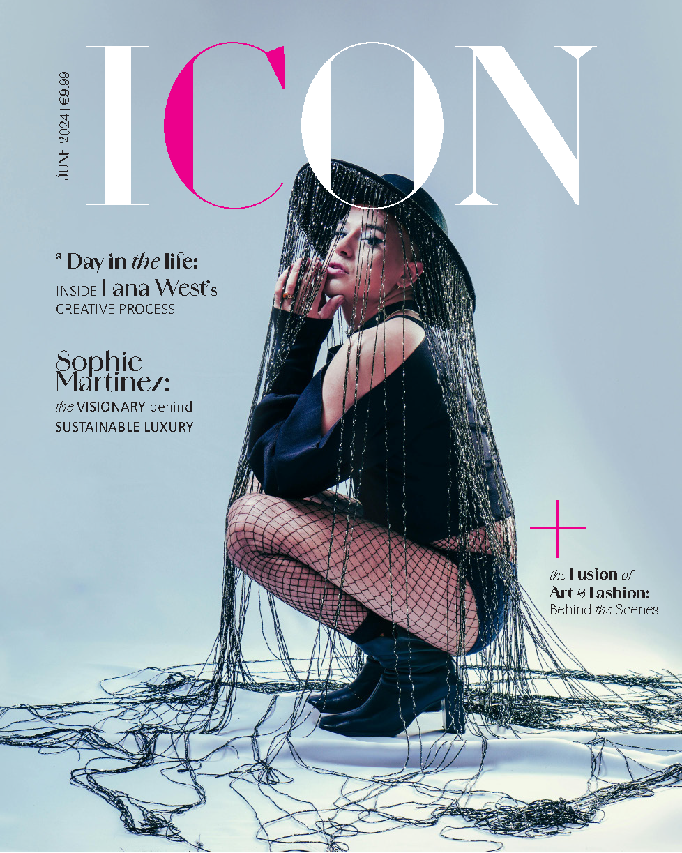 Fashion magazine cover featuring a woman crouching in fishnet stockings, black boots, and a dark hat, surrounded by black and silver wires cascading onto the floor, with large stylish text and headlines.