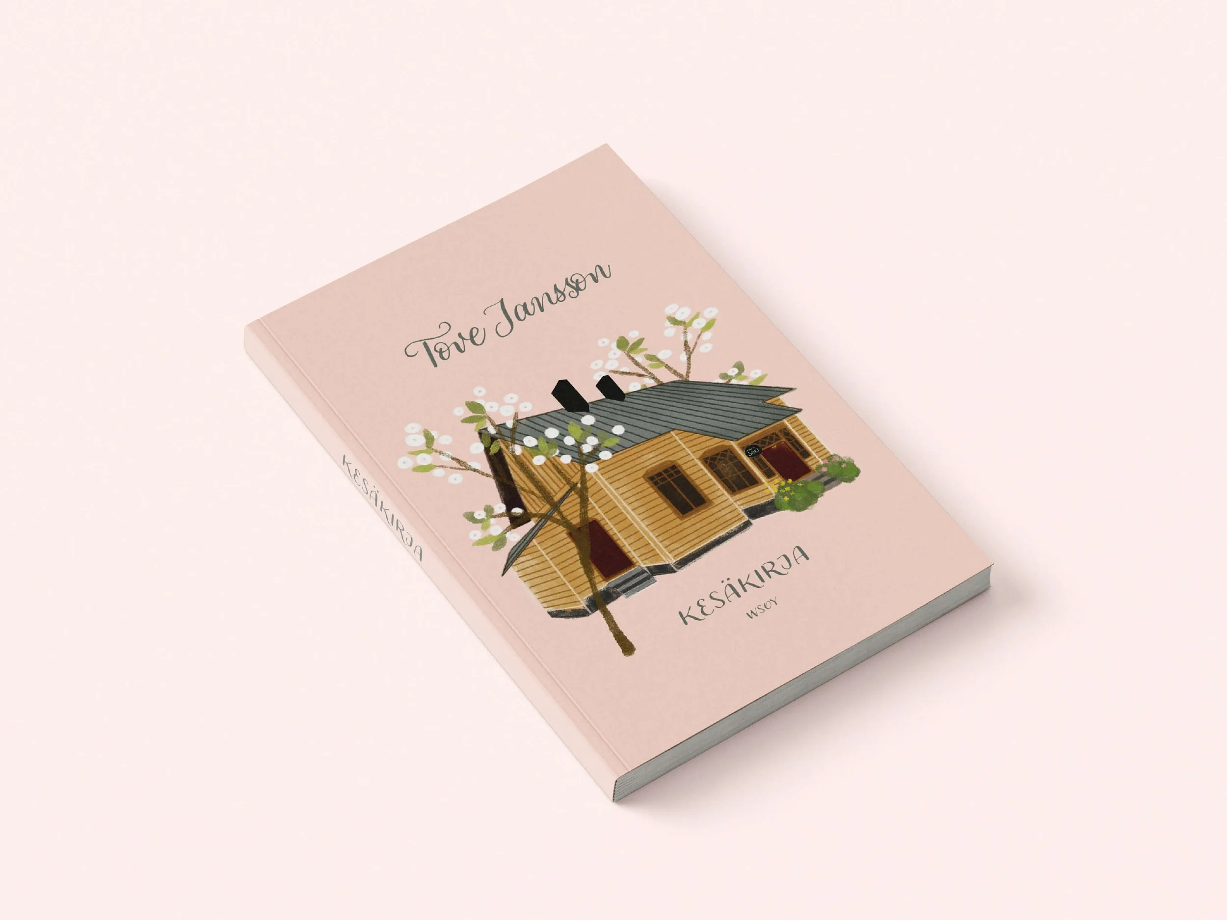 A pink book titled 'Tove Jansson' with an illustration of a wooden house and blooming white flowers and green foliage on the cover.
