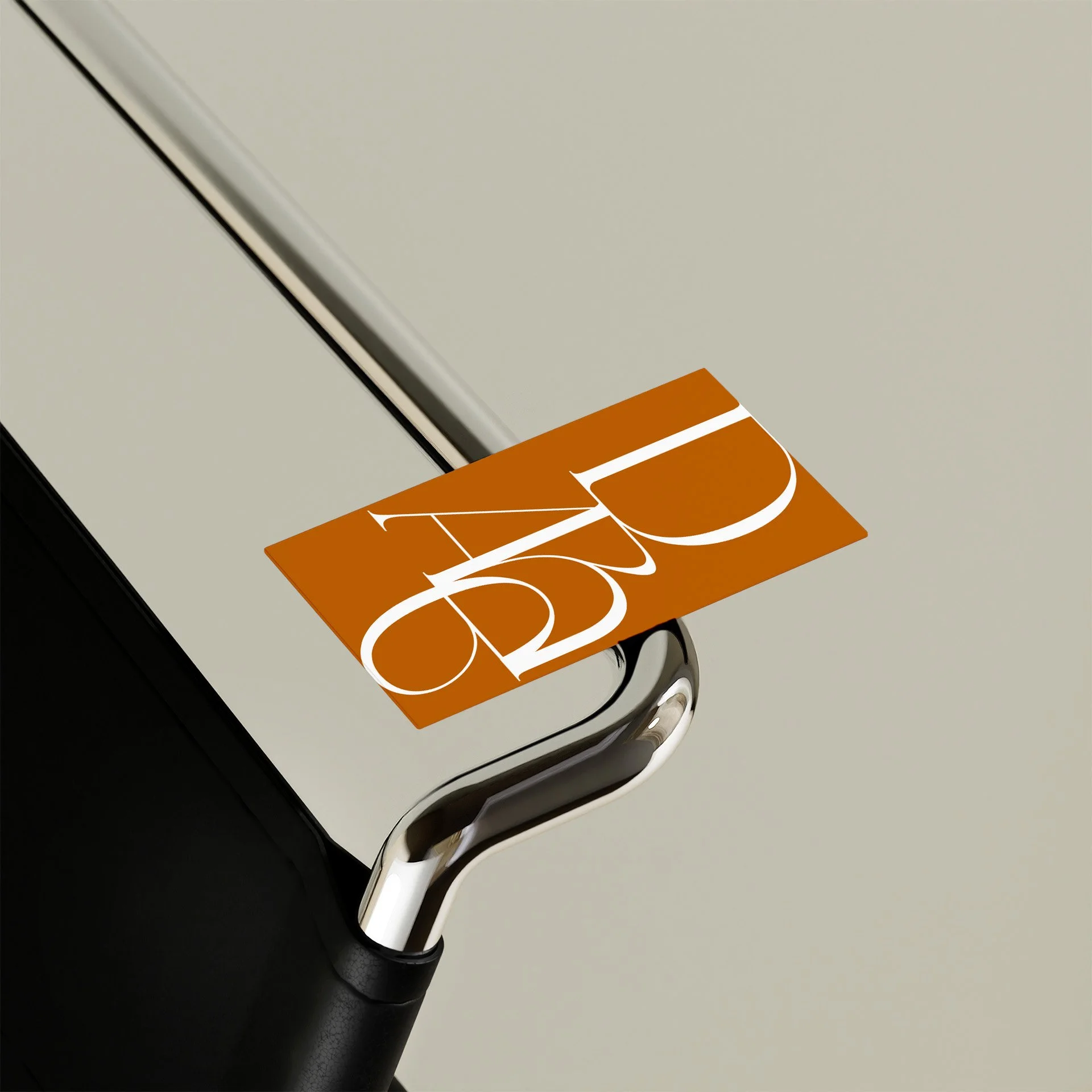 Close-up of a metallic chair with a an orange business card for Dare
