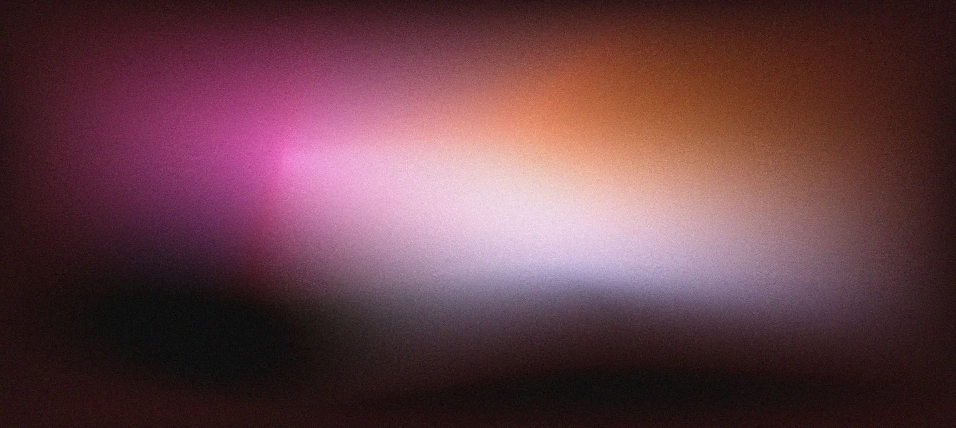 Blurred image with shades of pink, purple, orange, white, and black.