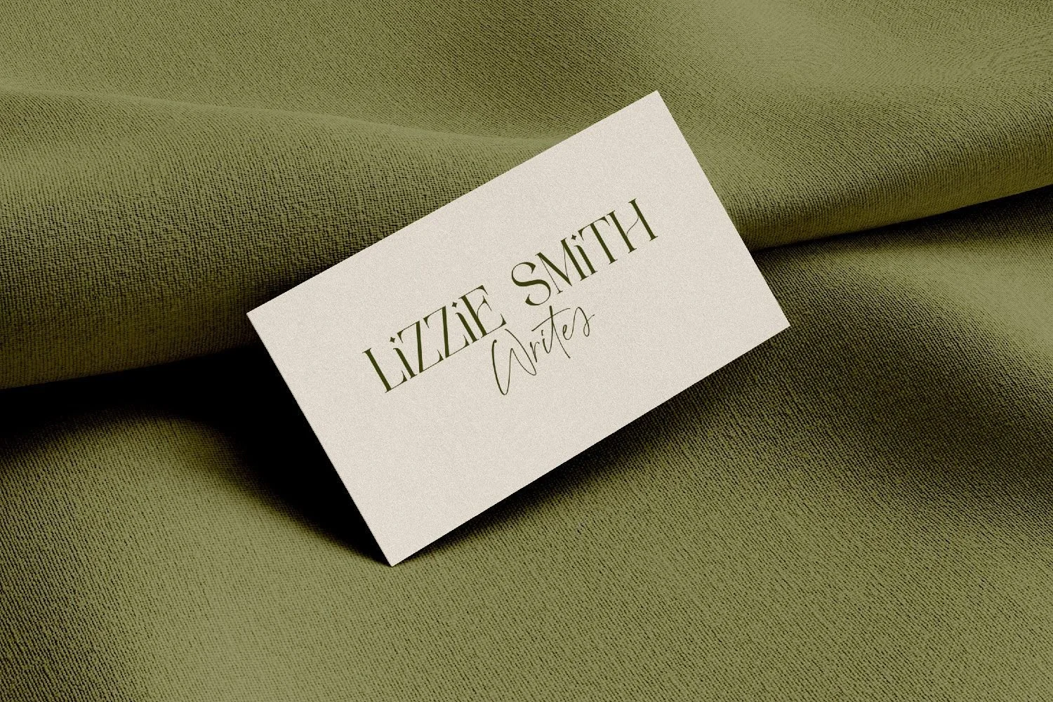 Business card design for Lizzie Smith Writes,  on olive-green fabric.