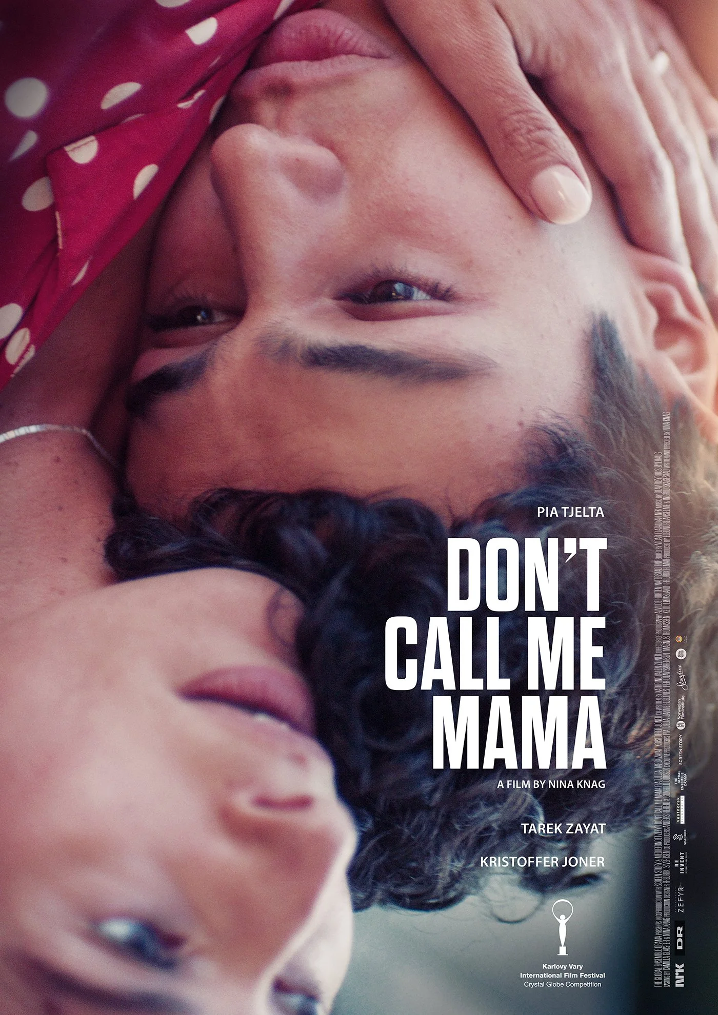 Close-up of two women lying down with their heads touching, one with dark curly hair and the other with straight hair, both appearing relaxed, with the title "Don't Call Me Mama" and credits overlayed.
