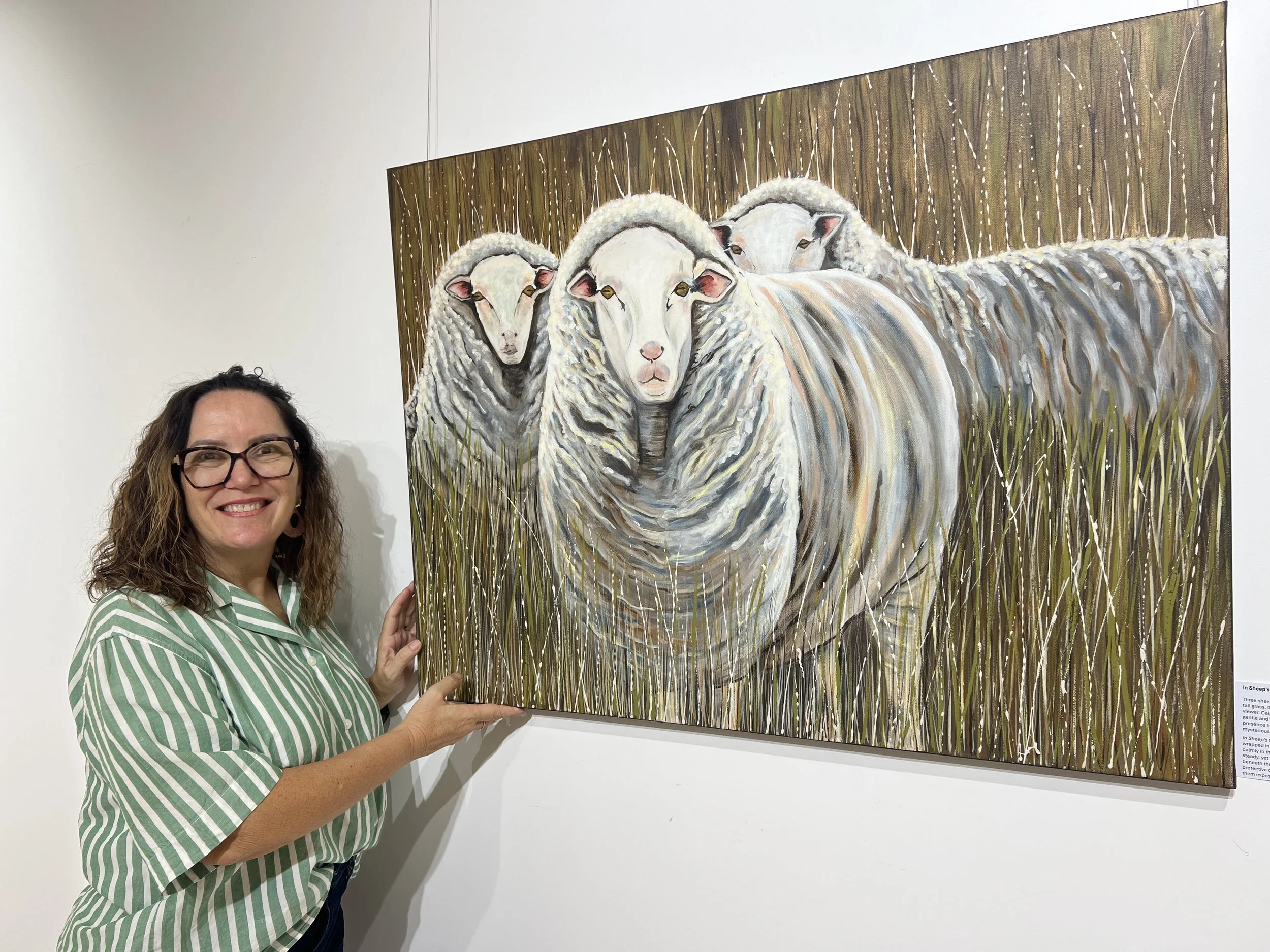 Artist Julie Stone standing by one of her prize winning artworks - In Sheeps Clothing