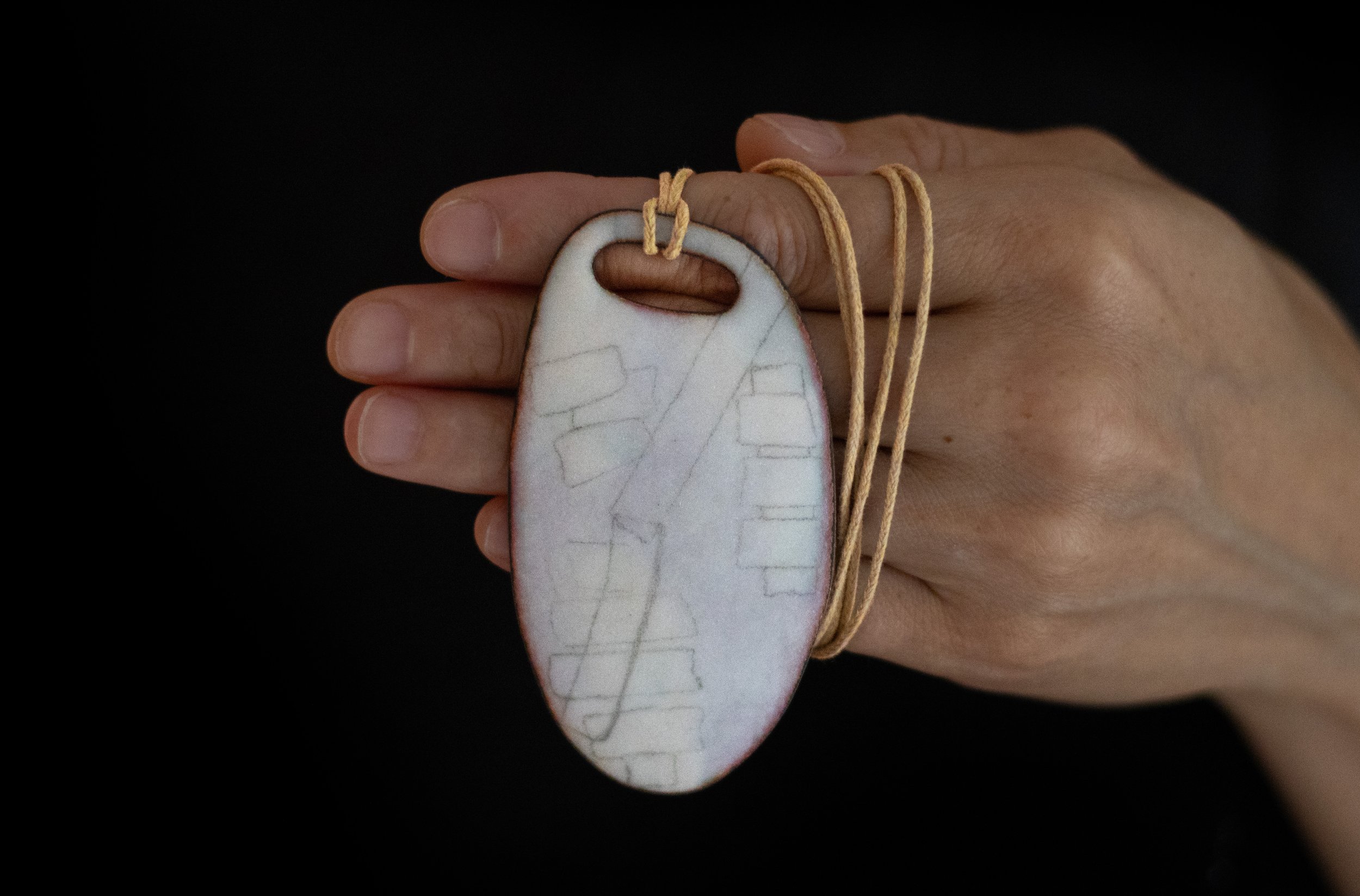 enameled pendant in hand.jpg