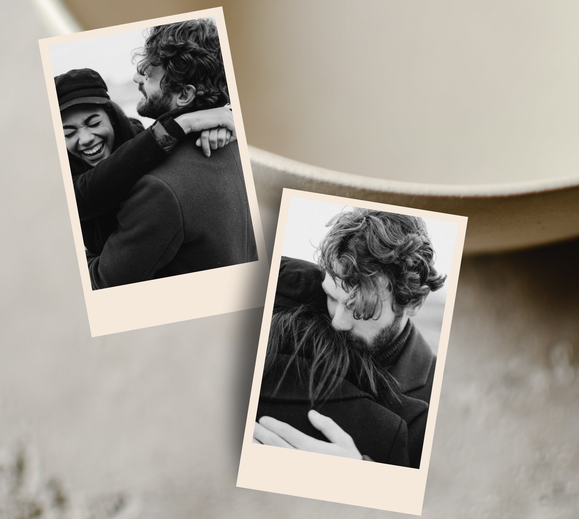 Two black and white photographs of a couple hugging, placed on a beige surface. One photo shows a woman smiling and embracing a man, the other shows a man and woman hugging tightly.