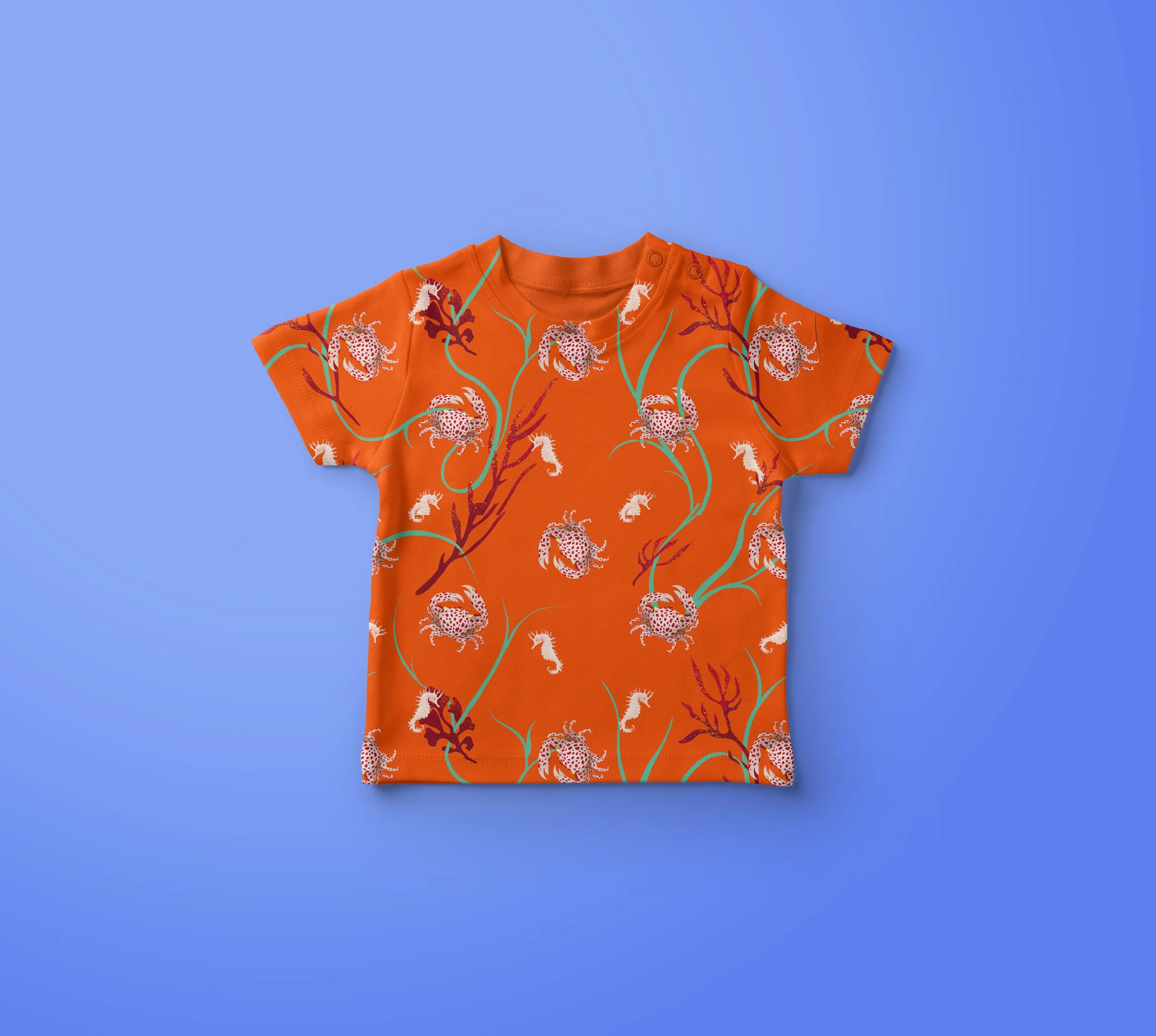 Orange T-shirt with a colorful jaguar and plant pattern on a blue background.