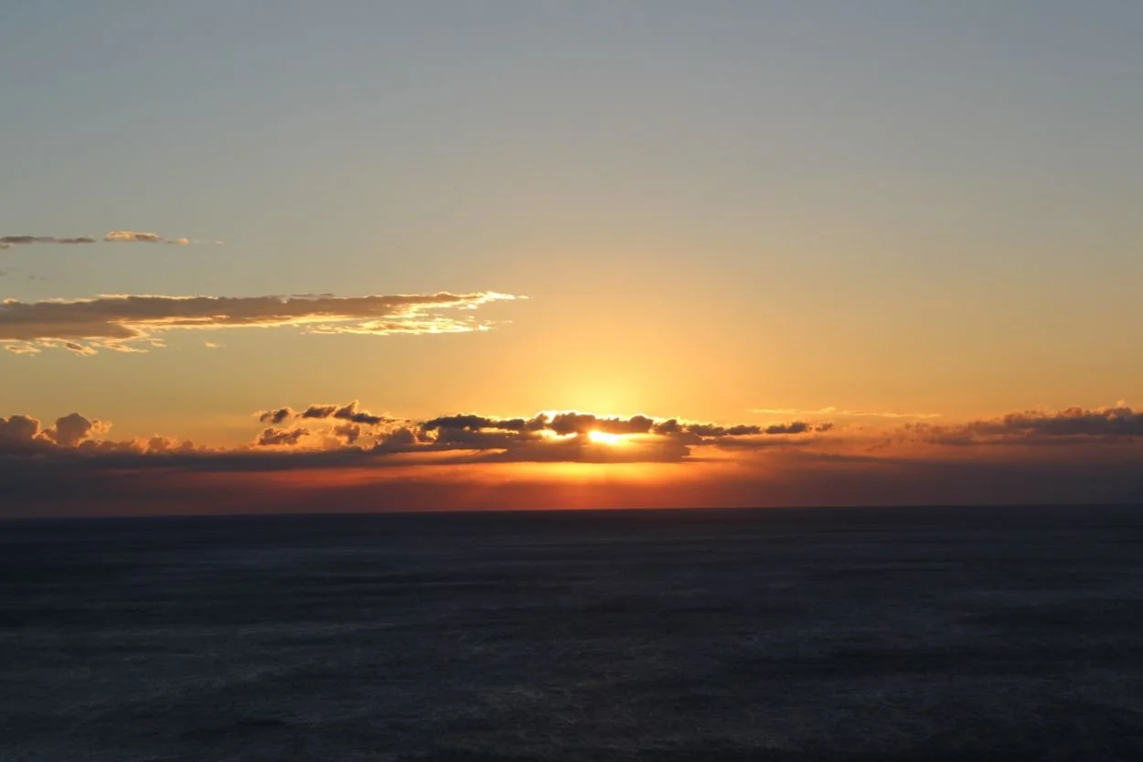 Sunset over the sea horizon