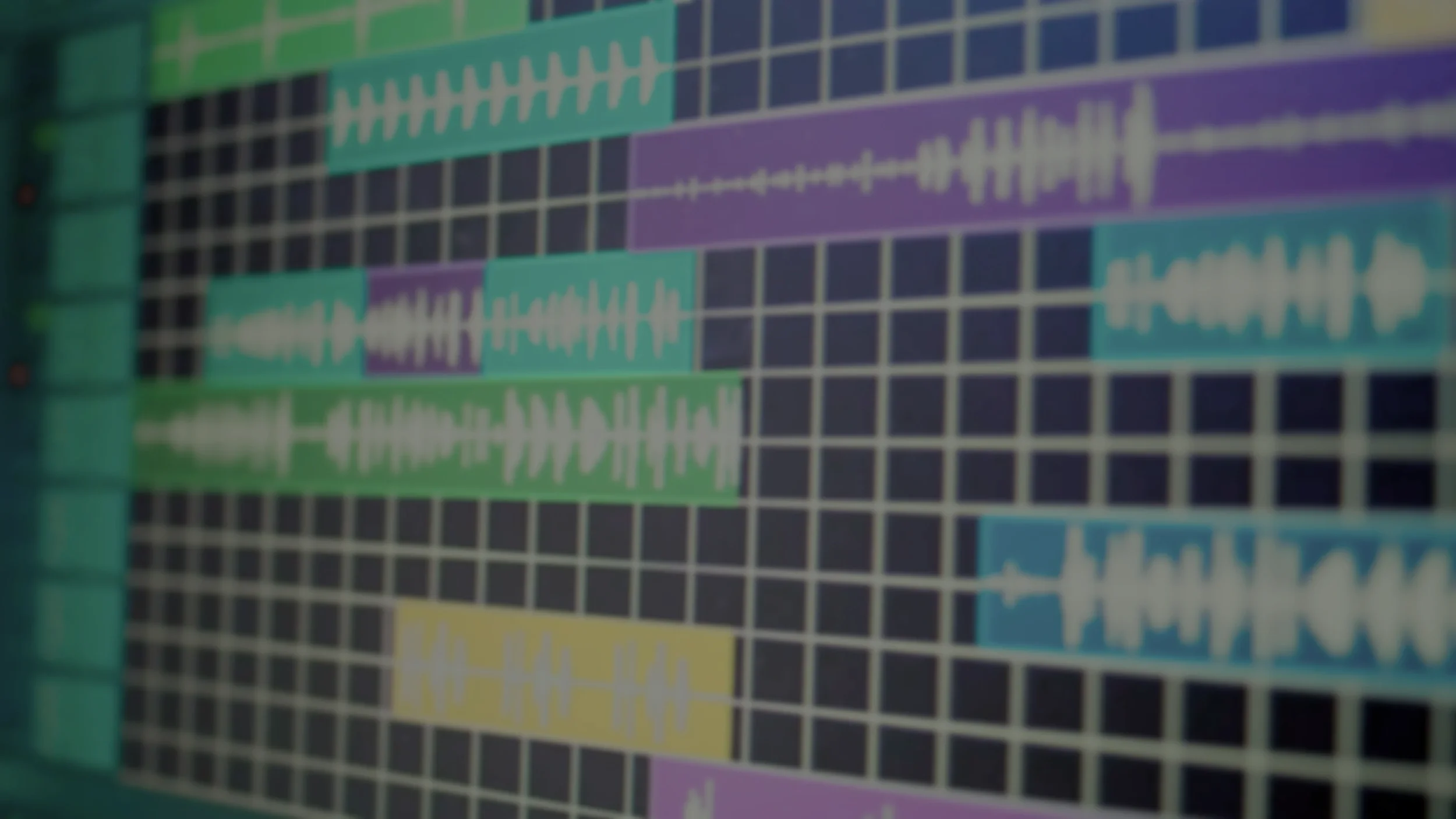 Screenshot of a digital audio workstation showing multiple colorful audio tracks on a grid.