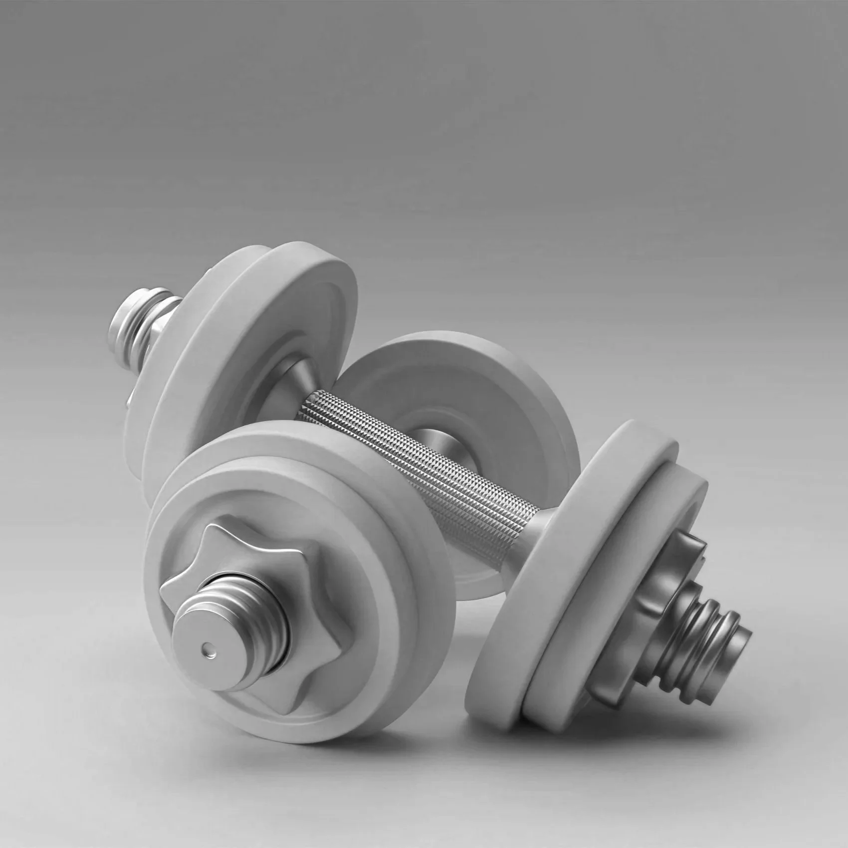 Zwei Kurzhanteln vor grauem Hintergrund