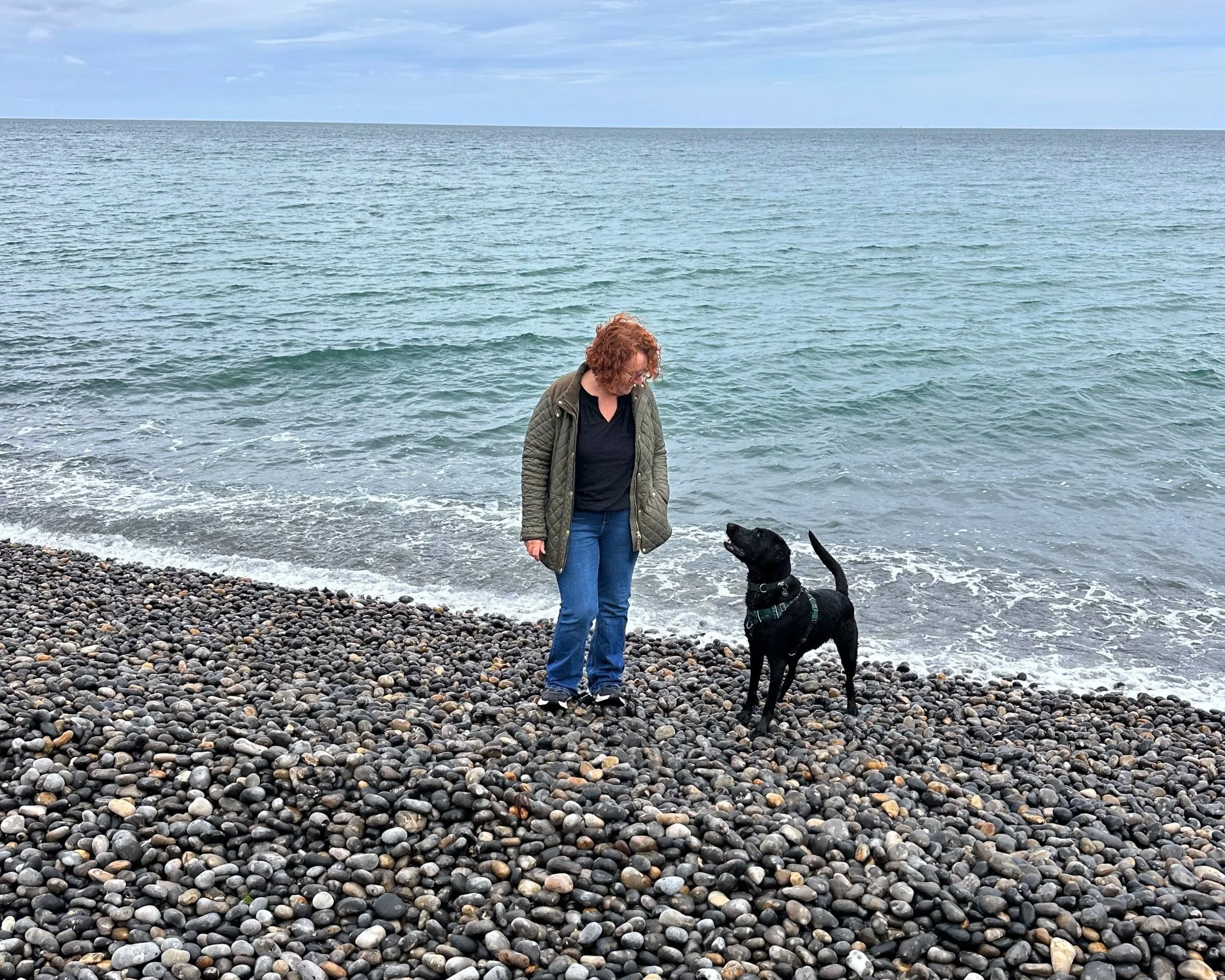 Vivienne Moore with her black Labrador Archie on a Norfolk beach.