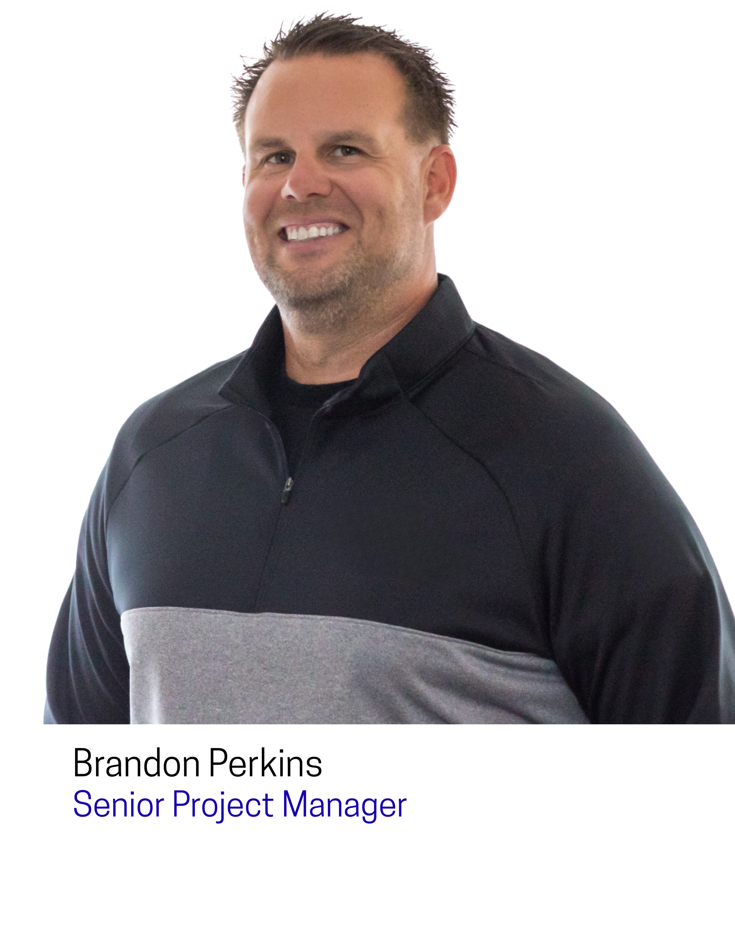 Photo of Brandon Perkins, Senior Project Manager, smiling, wearing a black and gray quarter-zip sweater, white background.