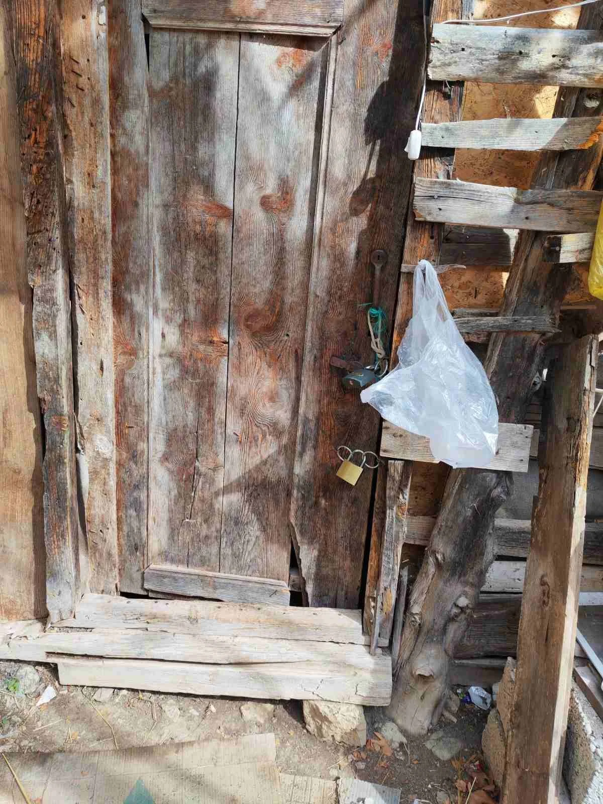 Eski ve yıpranmış ahşap kapı ve duvarlar.