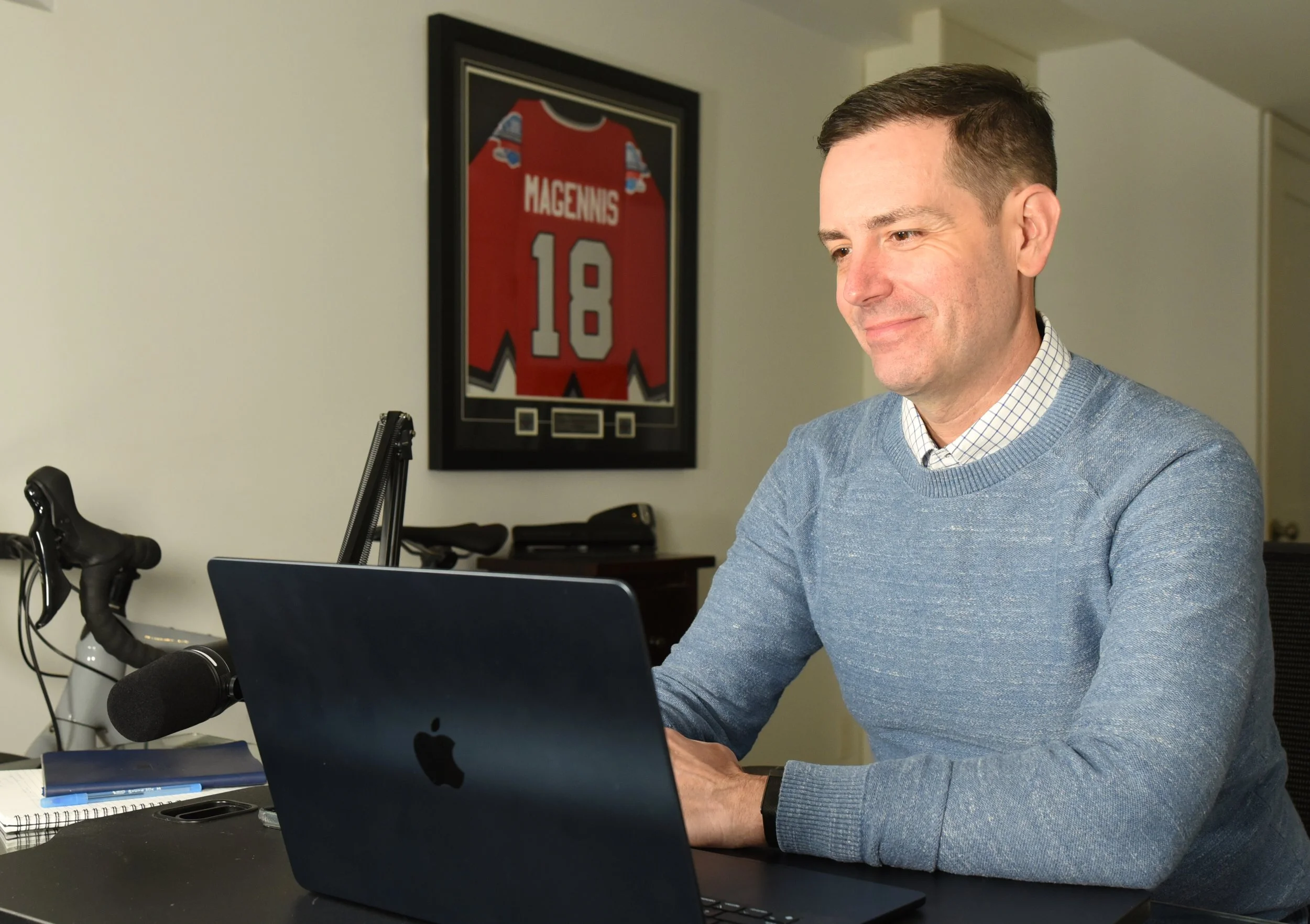 mage of Jason Magennis, high performance coach, sitting at his desk during a coaching call with an executive coaching client.