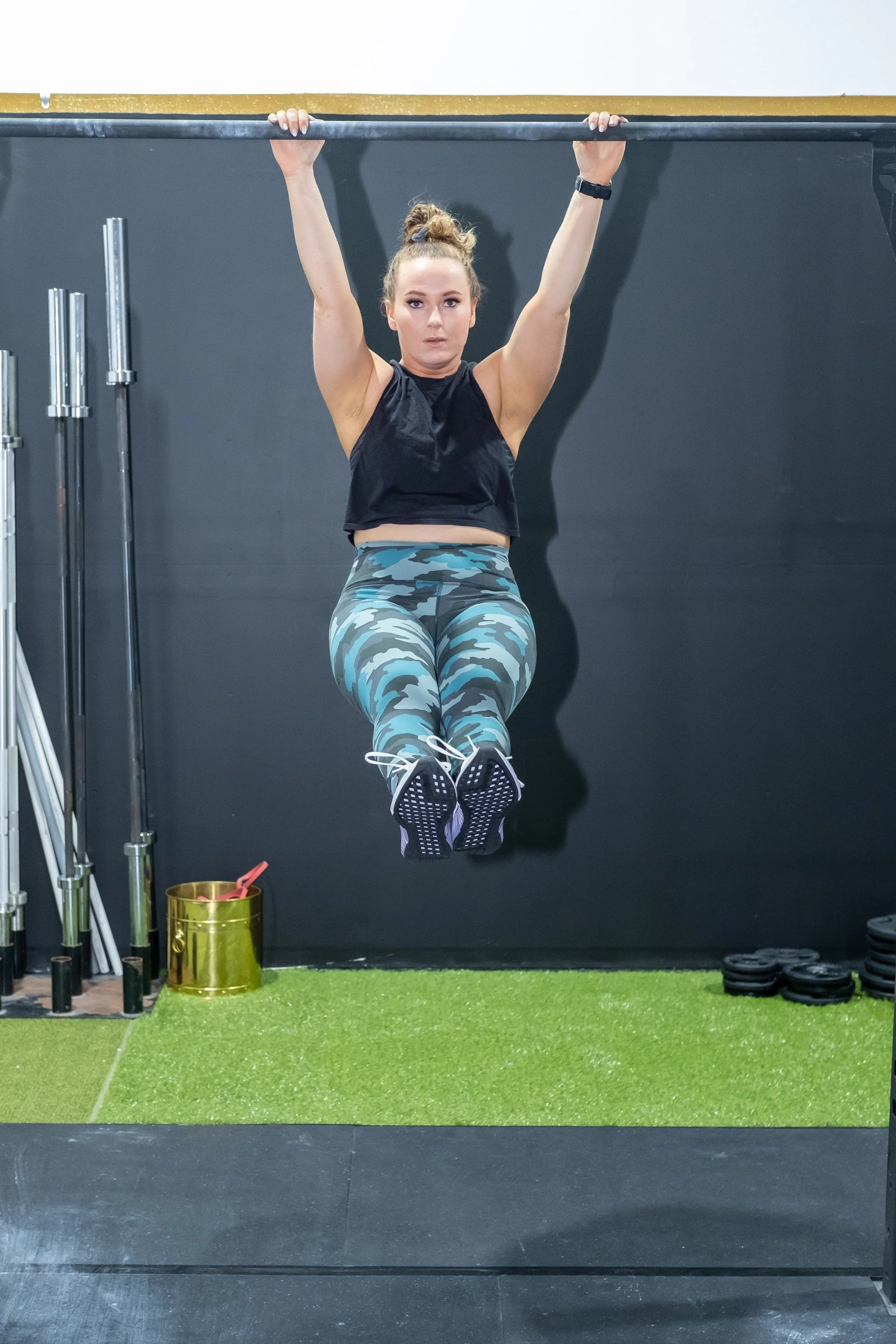 Women's Strength Coach doing a barbell hang in a private gym in Brantford Ontario