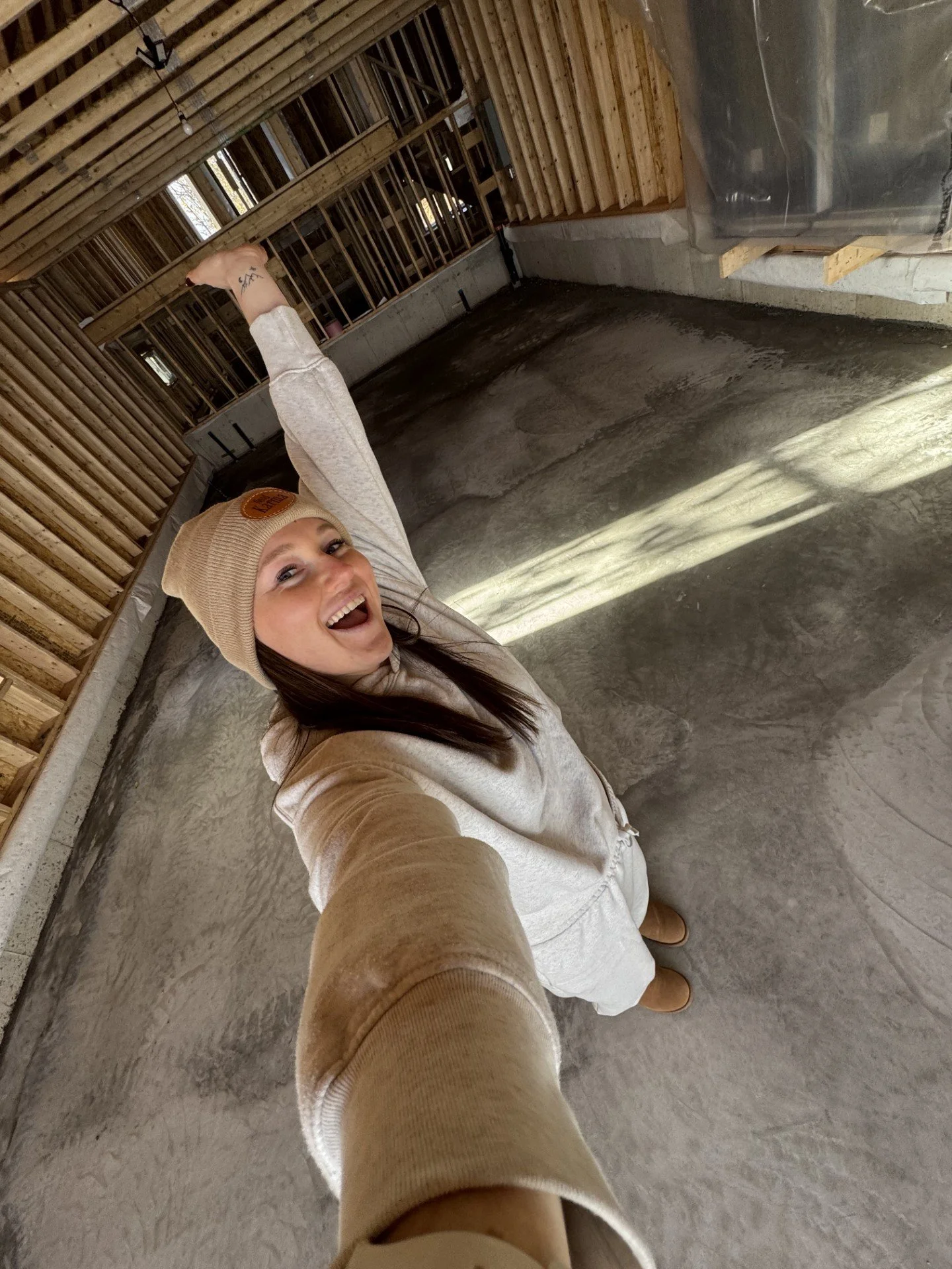 A female Strength Coach smiling in a selfie in her Private Gym in Brantford Ontario